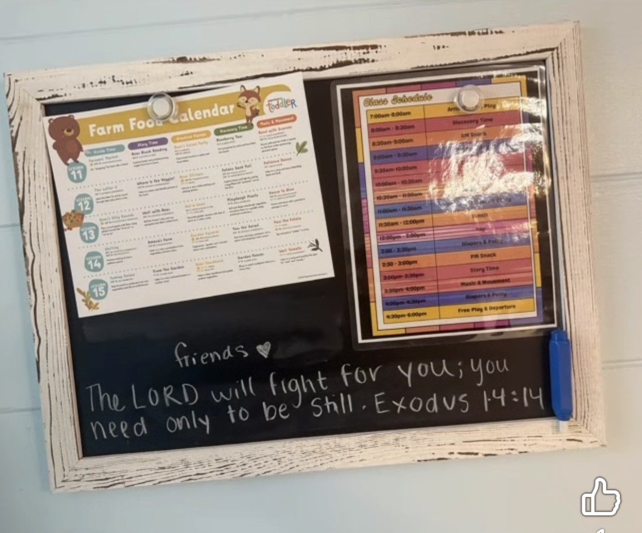 A framed bulletin board with a farm food calendar, a schedule, and a motivational message with a Bible verse from Exodus 14:14.