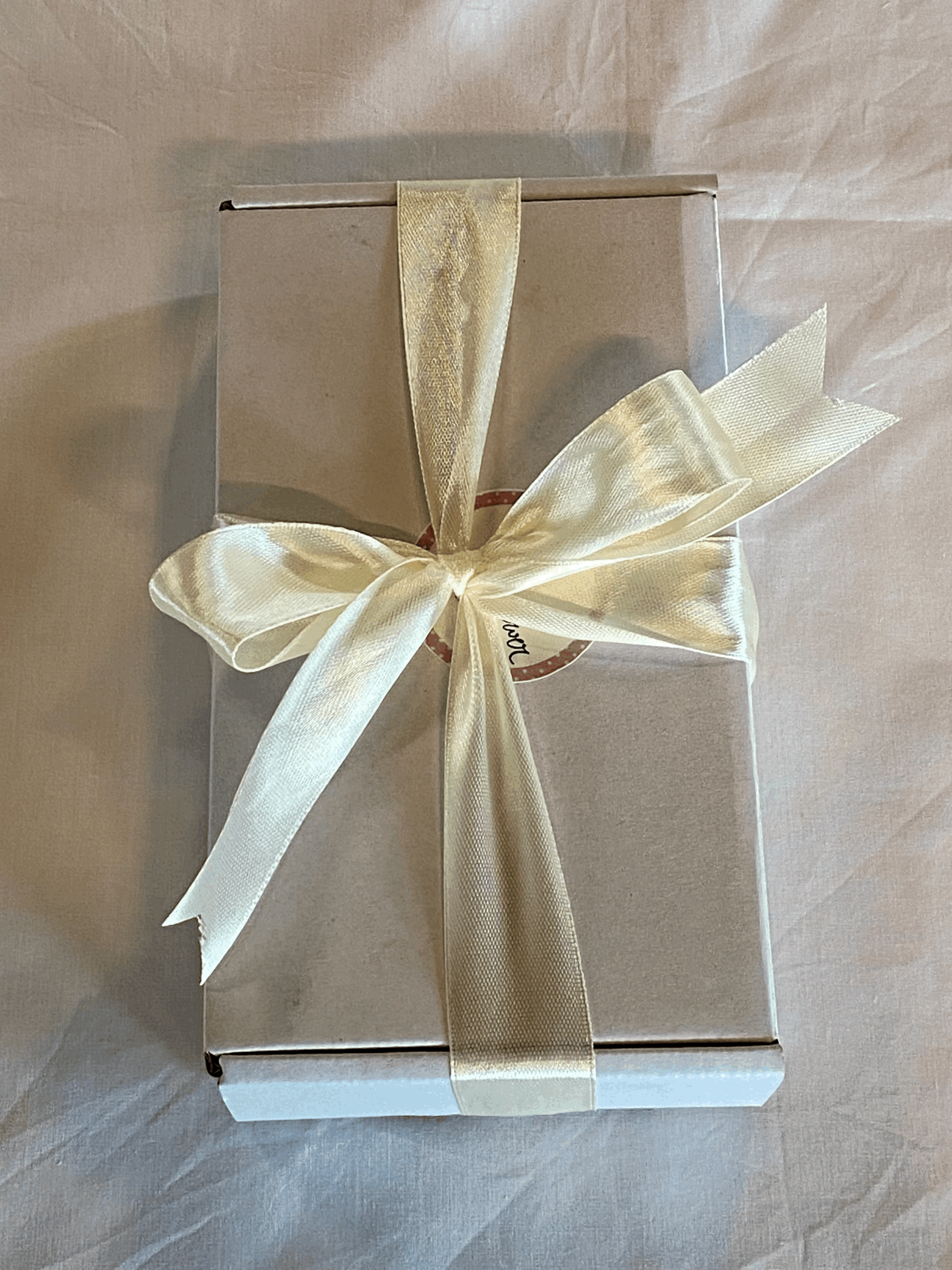 white gift box with ivory satin ribbon tied on your phone case gift box