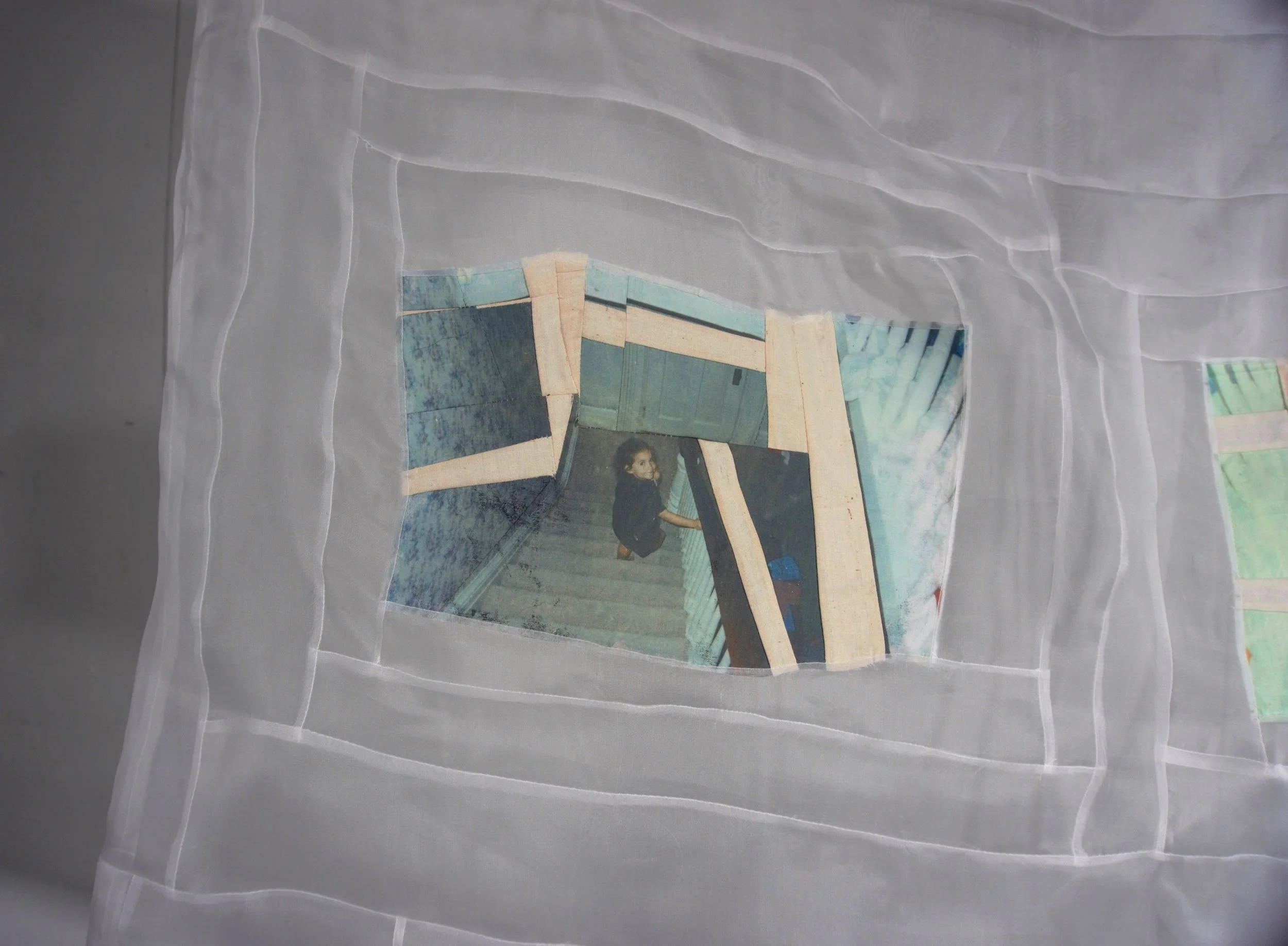 A image transfer textile collage, pieced image of a child walking down a staircase looking back at the viewer pieced with transparent silk fabric in a log cabin improvisational motif.