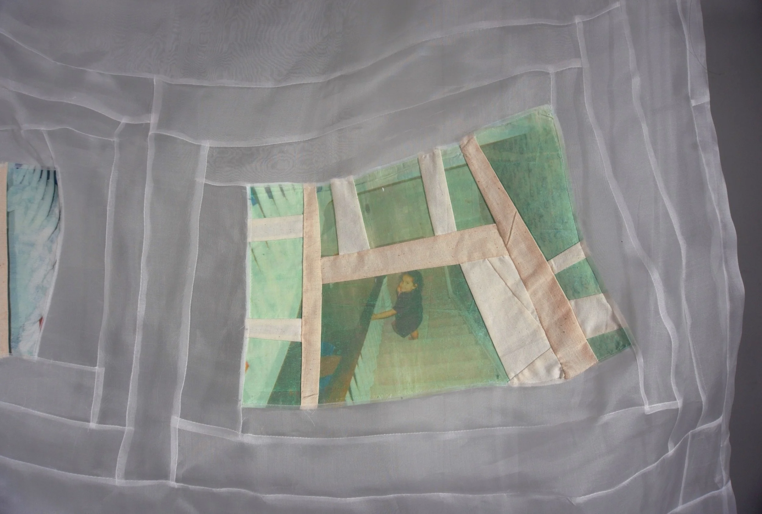 A image transfer textile collage, pieced image of a child walking down a staircase looking back at the viewer pieced with transparent silk fabric in a log cabin improvisational motif., creating a layered effect.