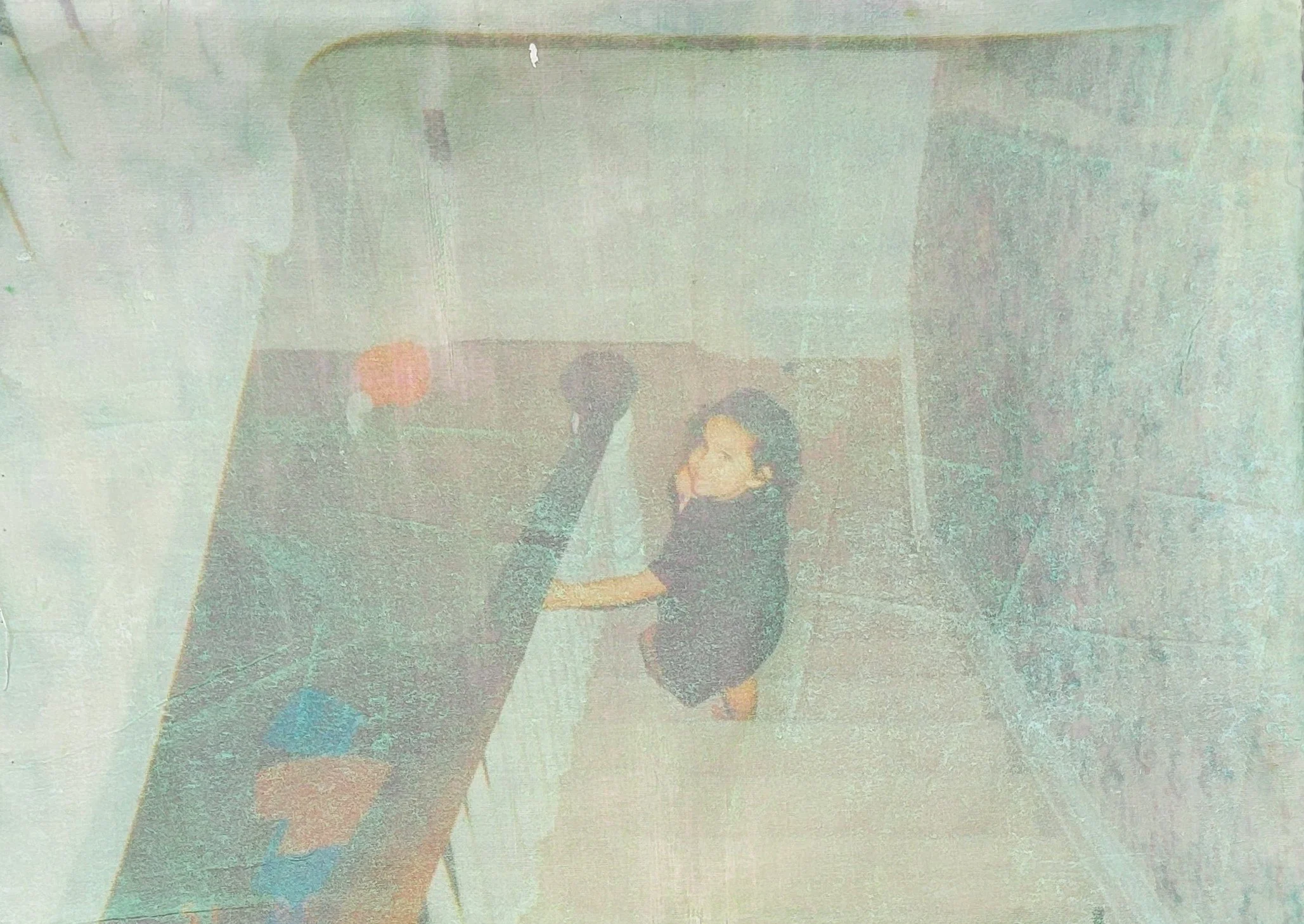 A child dressed in dark clothing, holding onto stair banister, standing on a staircase looking back at the camera.