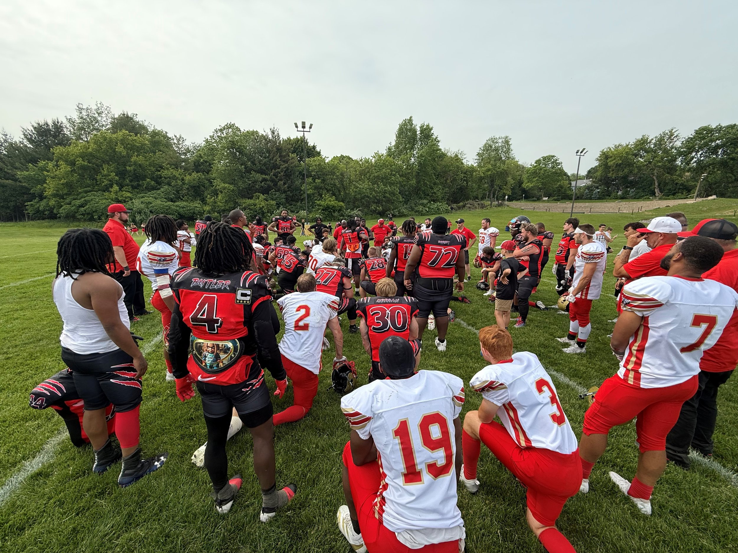 Group meeting and prayer between the Dubuque Miners and the Red Cedar Raptors following their game on June 7th, 2025