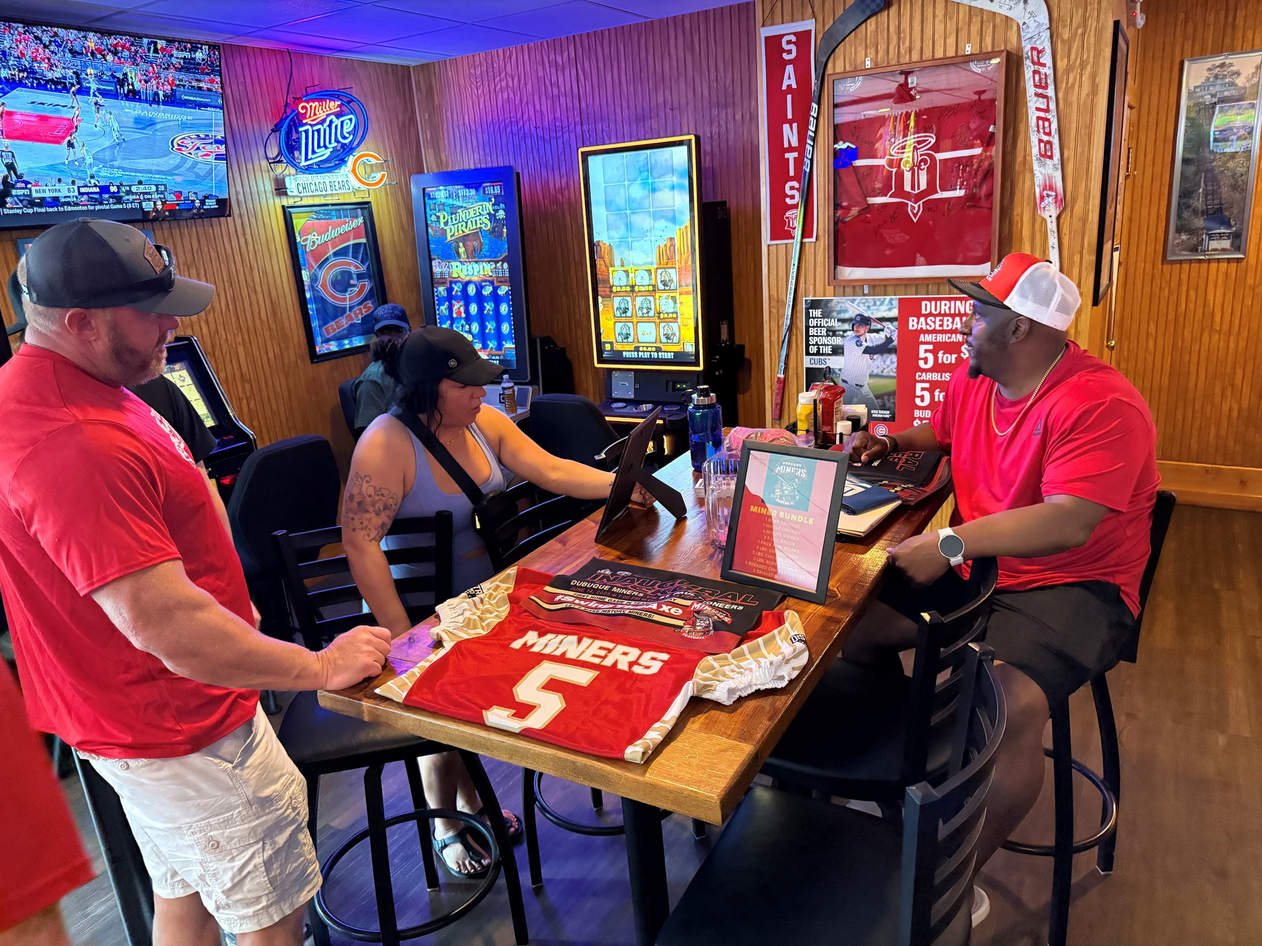 Coach Thomas explaining a raffle during the Miners Pre-Game Tailgate at our Platinum Sponsor, the Dog House Lounge, on June 14th, 2025