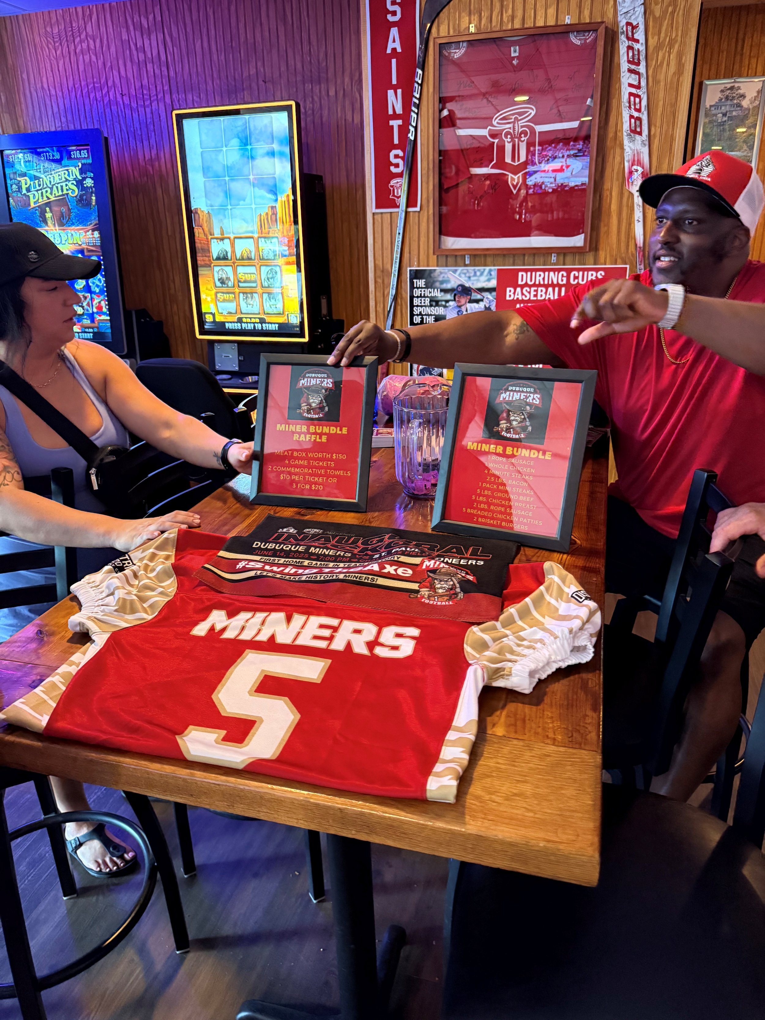 Coach Thomas explaining a raffle during the Miners Pre-Game Tailgate at our Platinum Sponsor, the Dog House Lounge, on June 14th, 2025