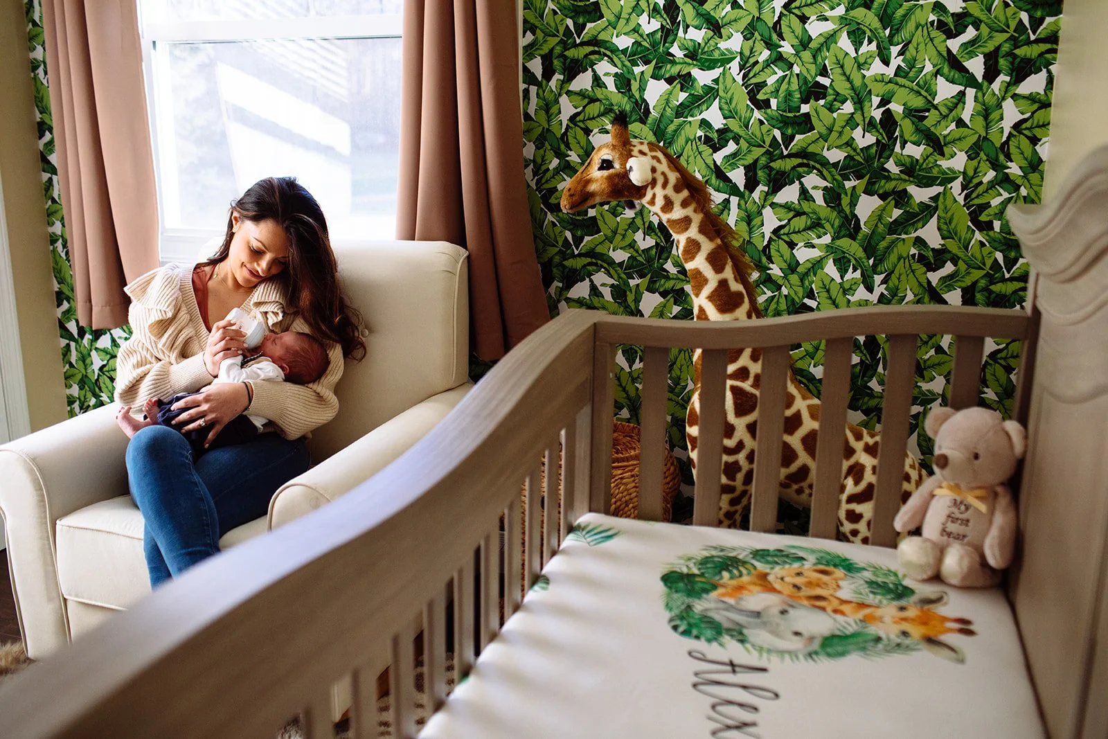 north kingstown new mom holding her baby in the nursery, professional photo by Jennifer Lamy for Zenobia Studios.