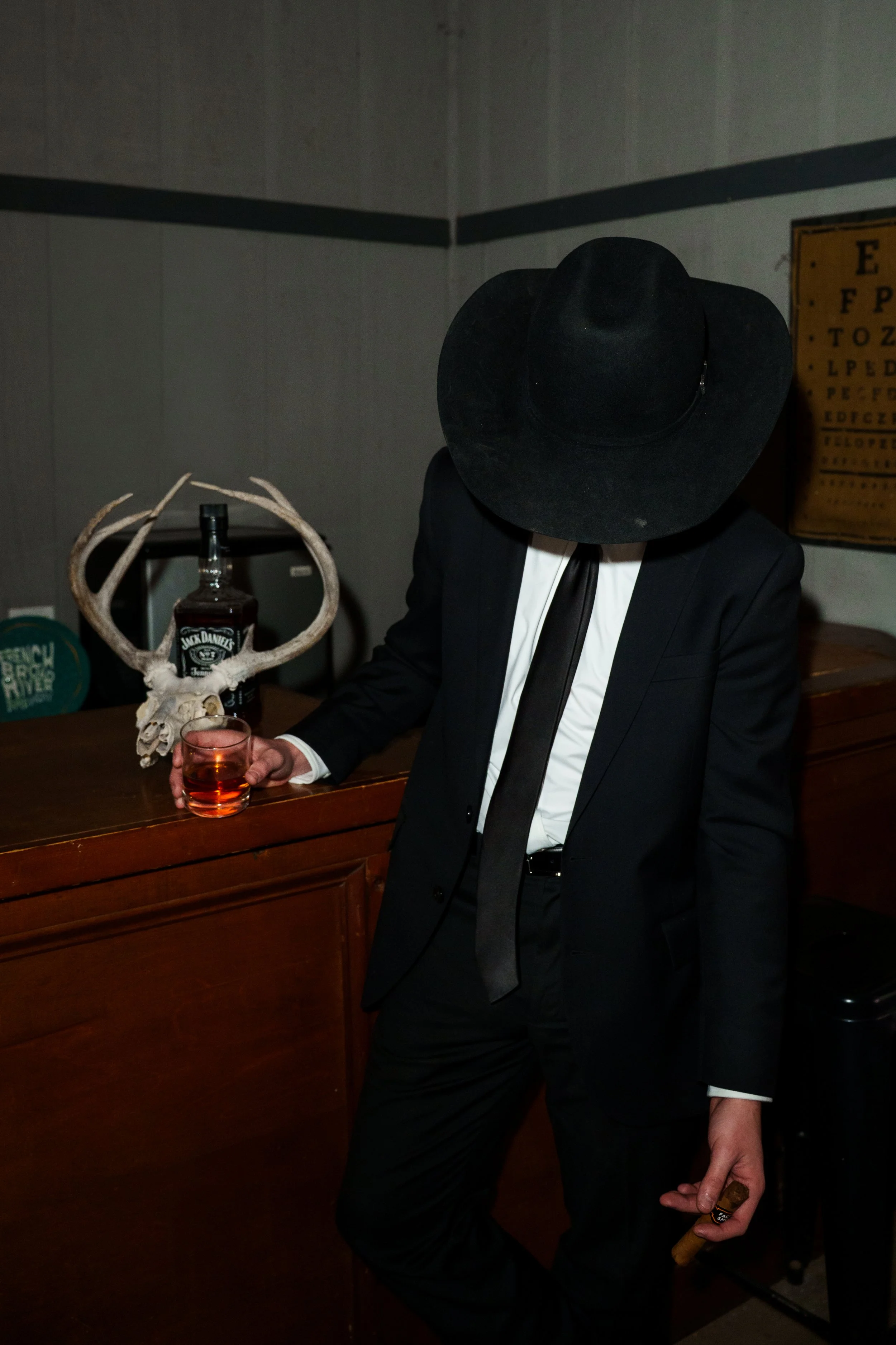 Groom holding a glass of whiskey and a cigar