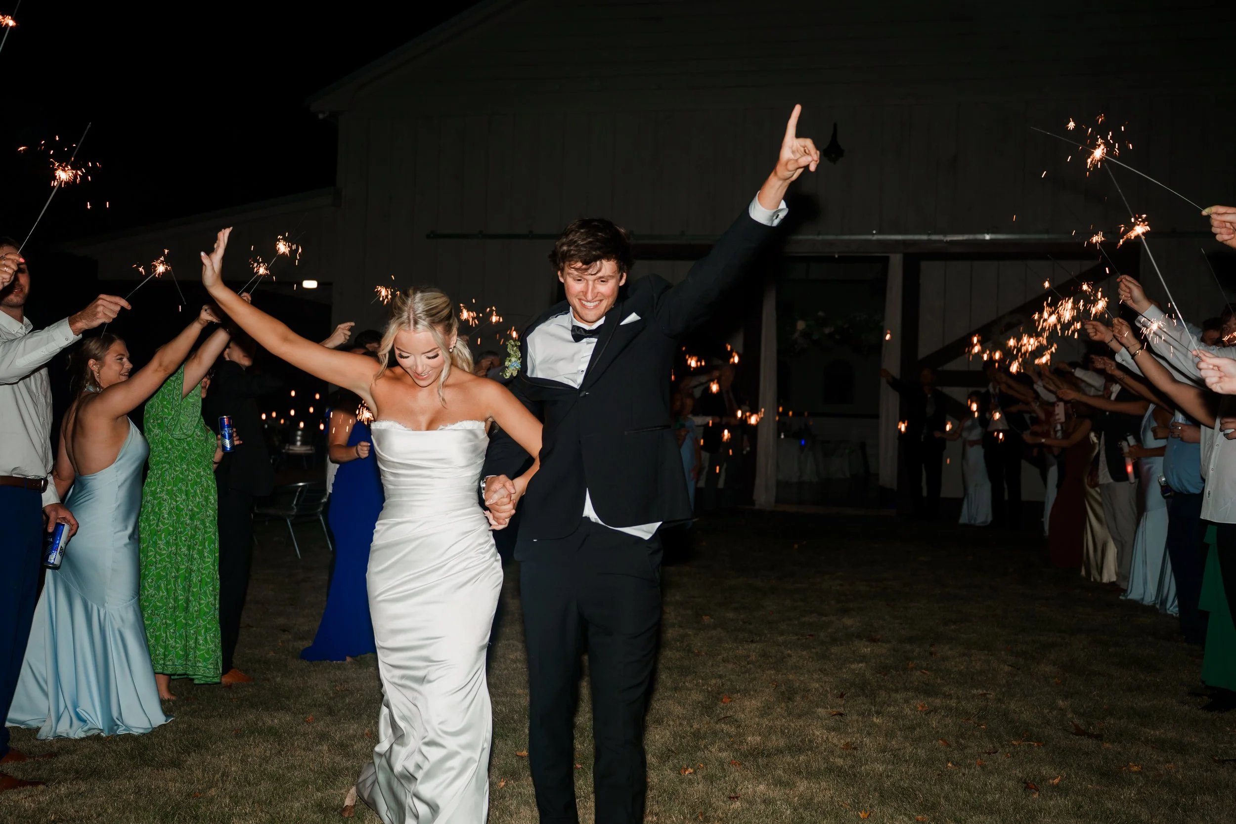 Bride and groom dancing through the sparkler tunnel for their exit from the reception at Sanoah Springs in Georgia