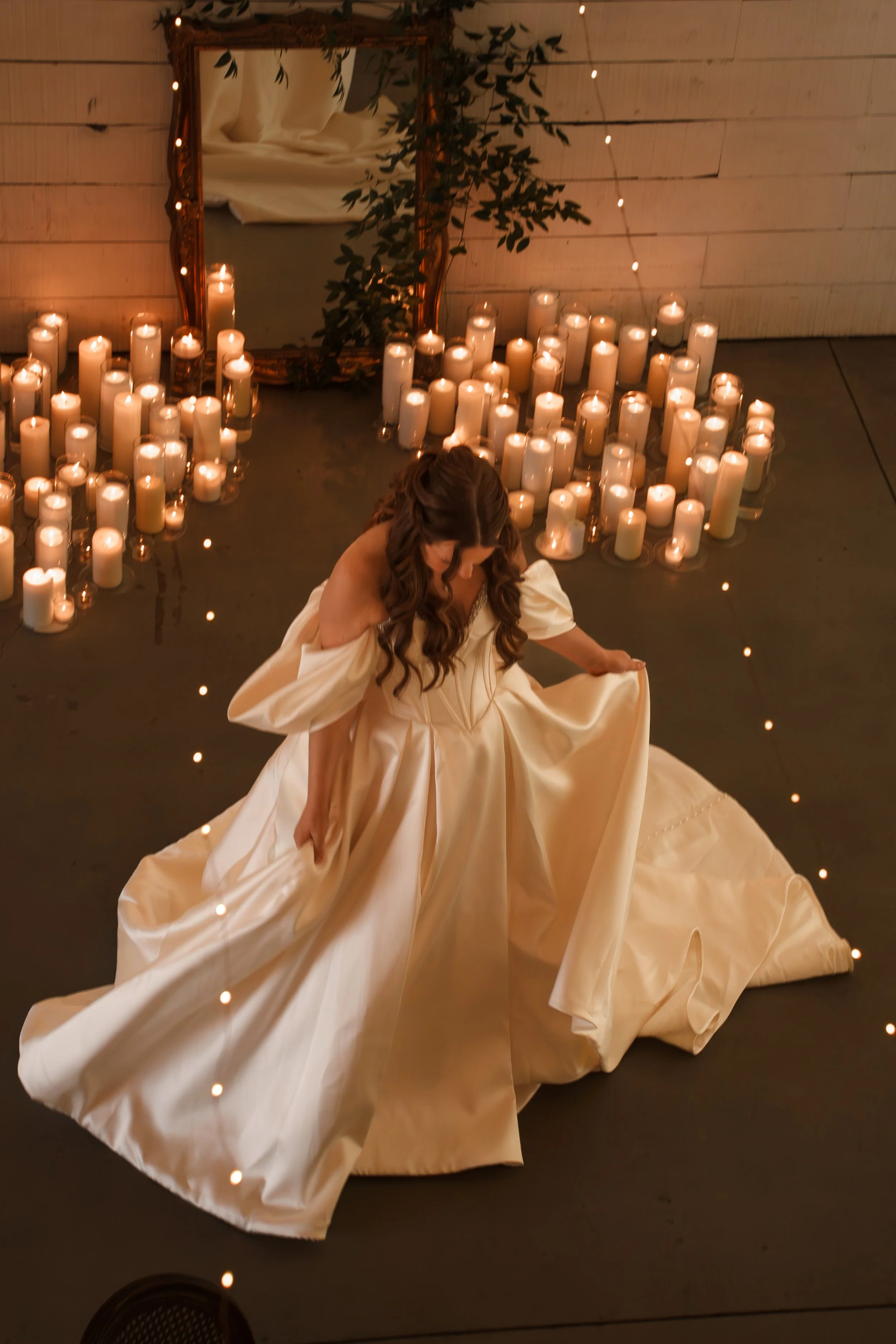 Bride dancing in her candlelit reception space