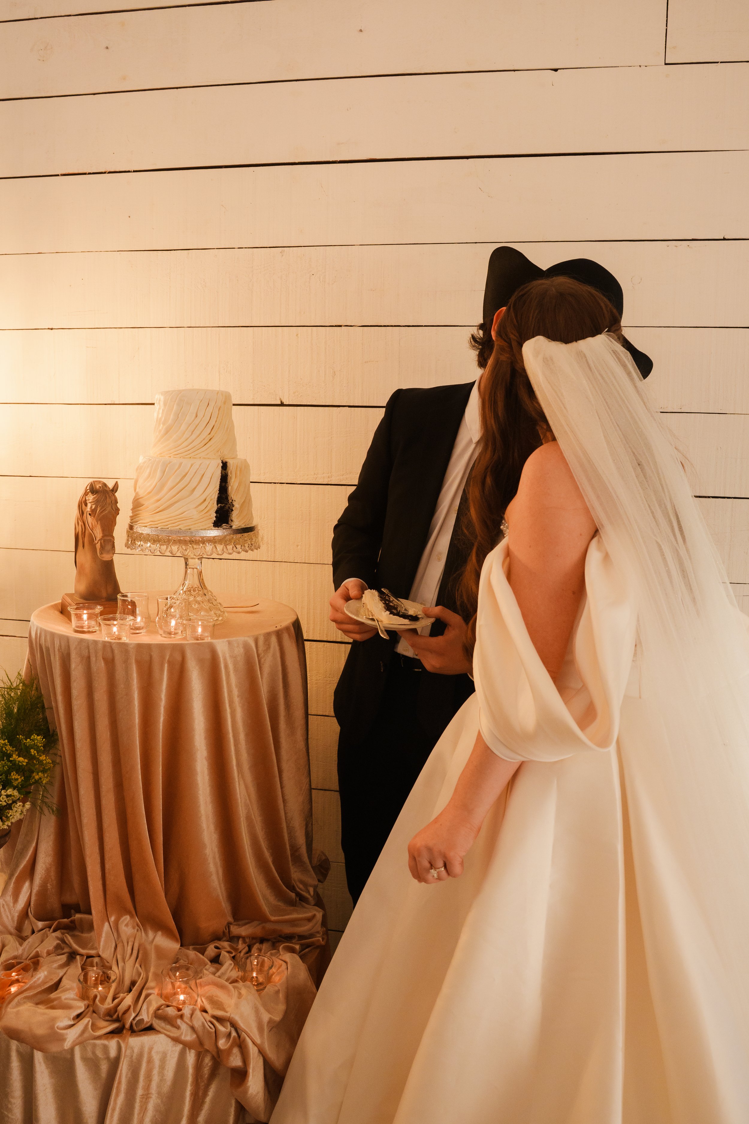 Bride and Groom kissing after cutting their cake