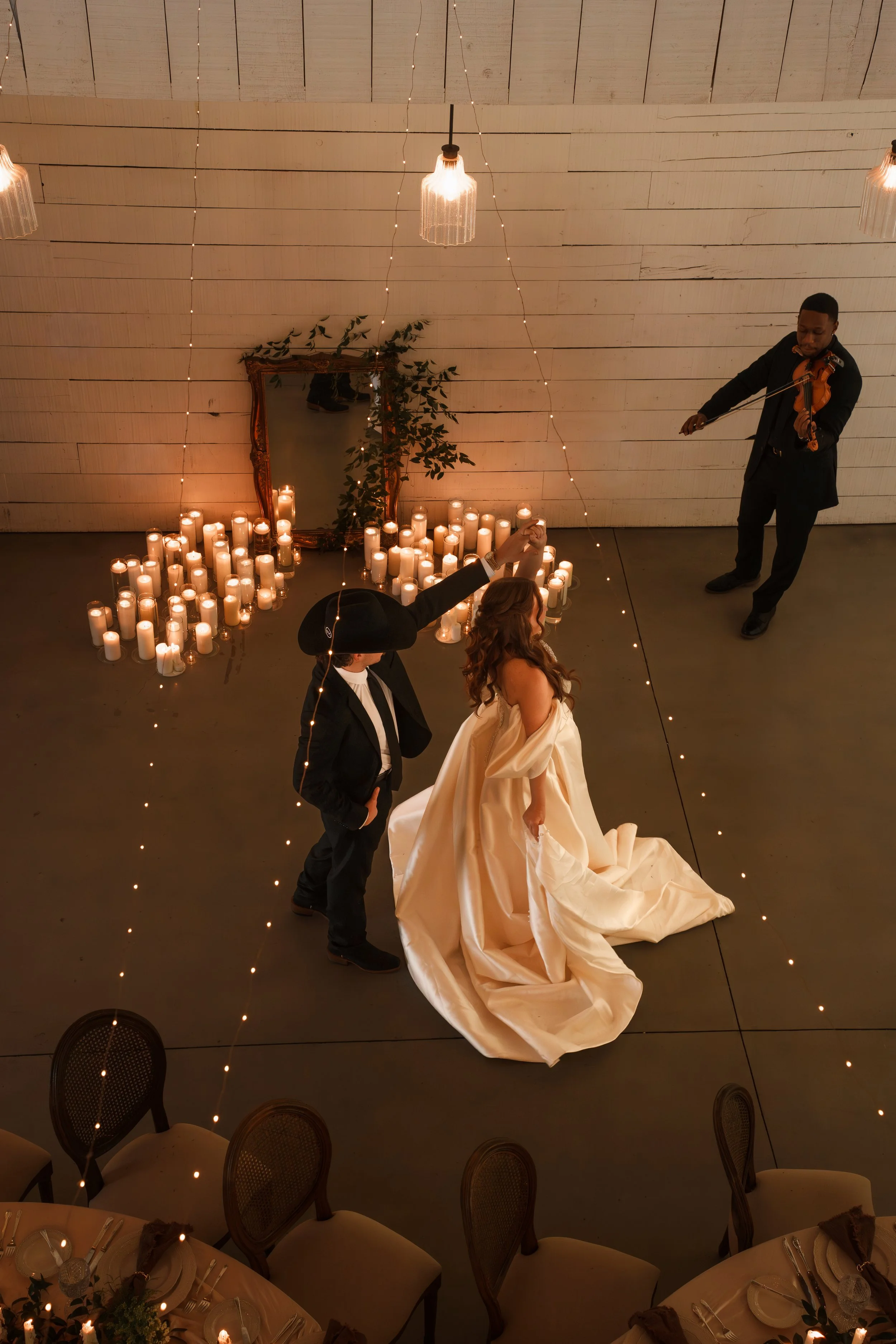 Bride and groom dancing with a violinist playing for them