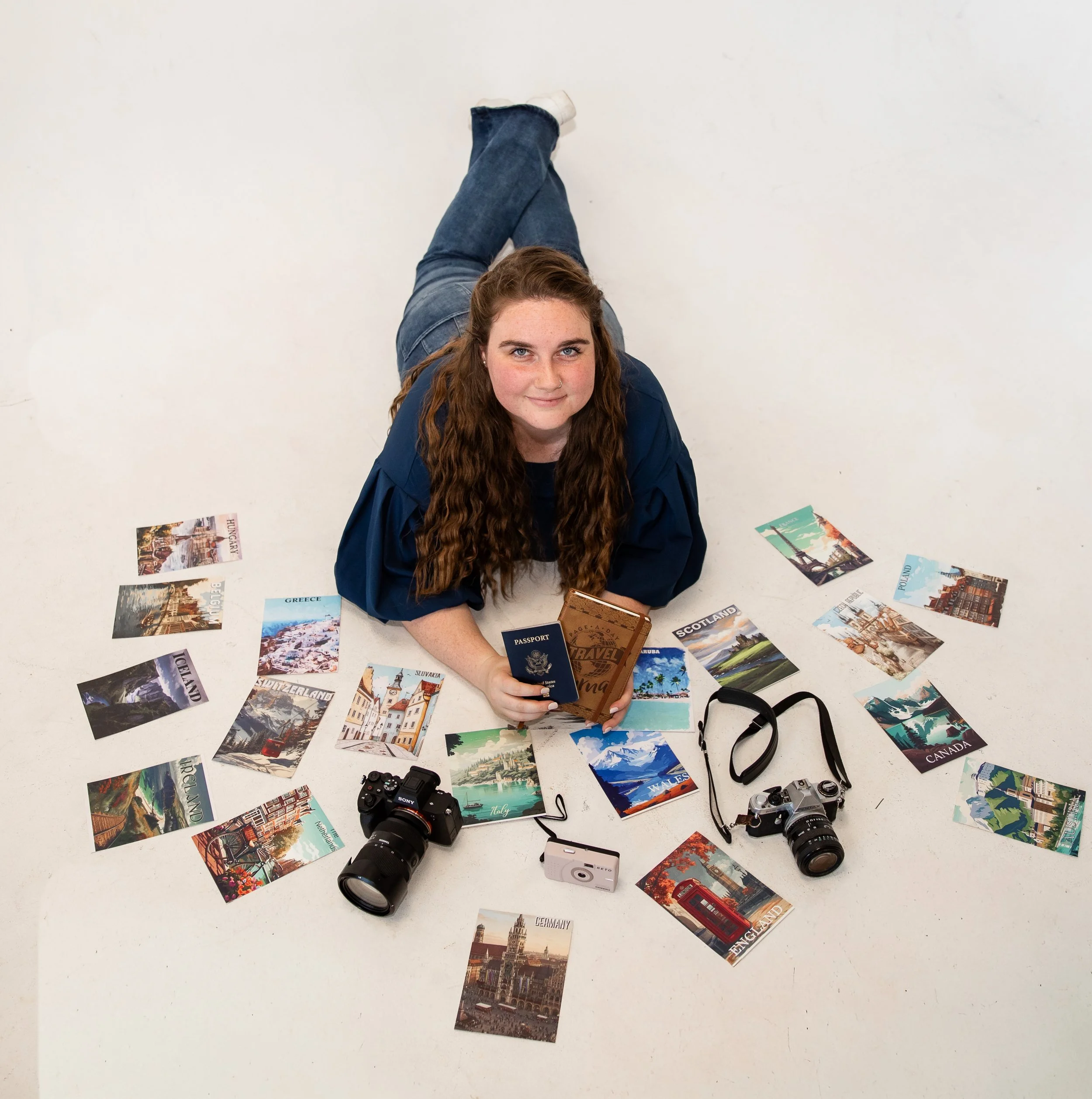 Photographer with post cards from 20 countries