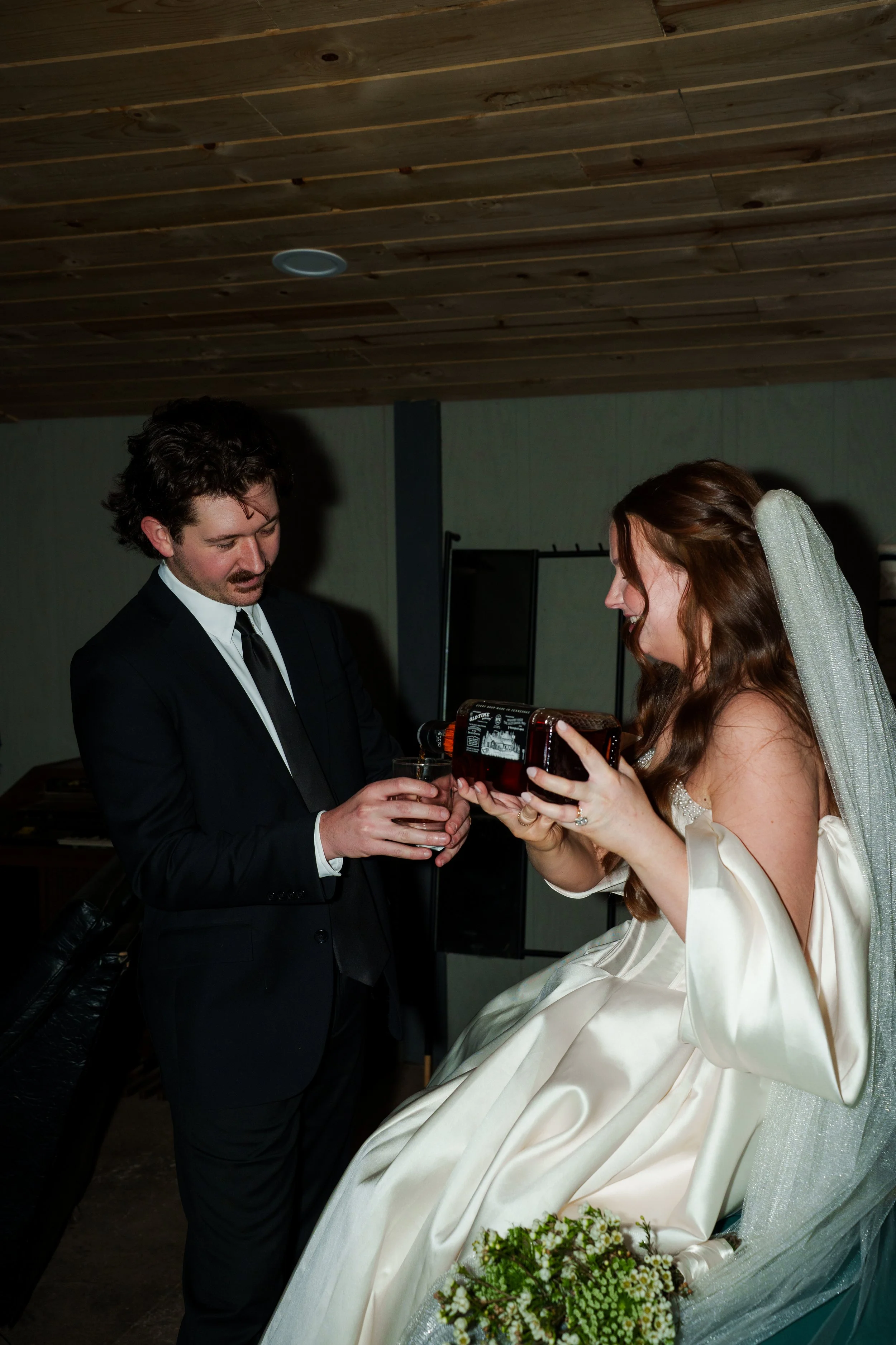 Bride pouring the Groom Jack Daniels 