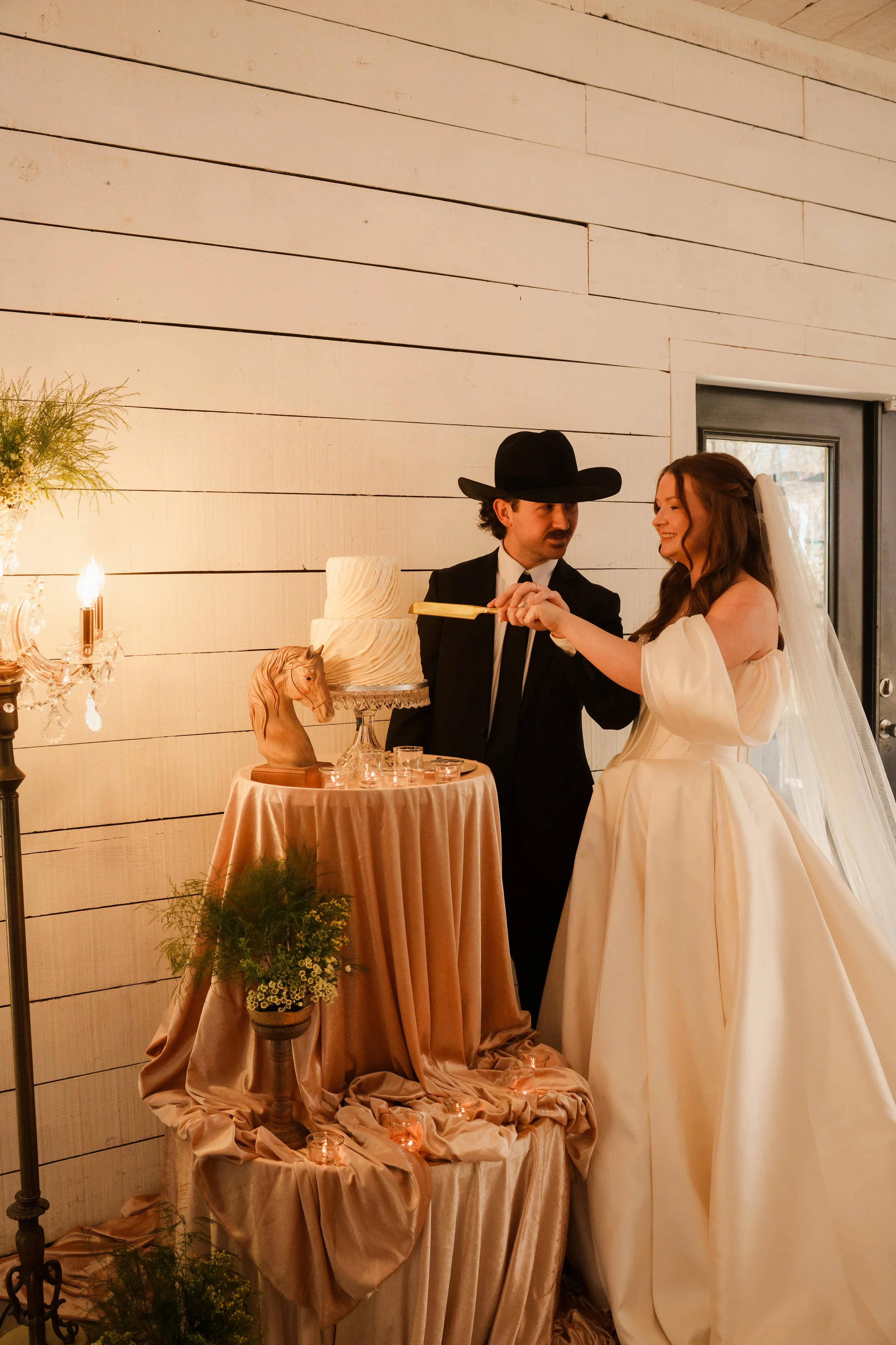 Groom admiring his bride while they cut their cake