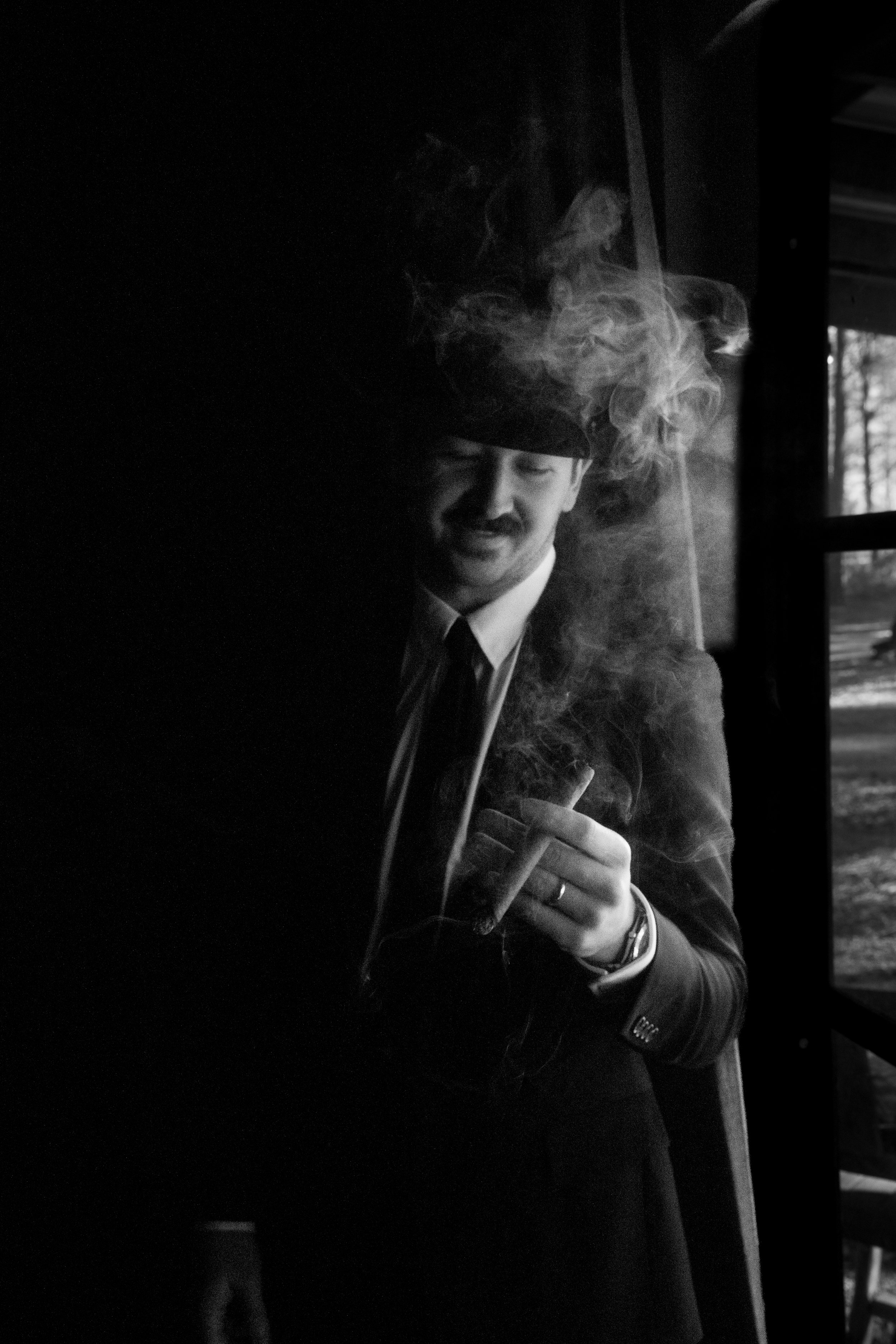 Groom smoking a cigar, black and white