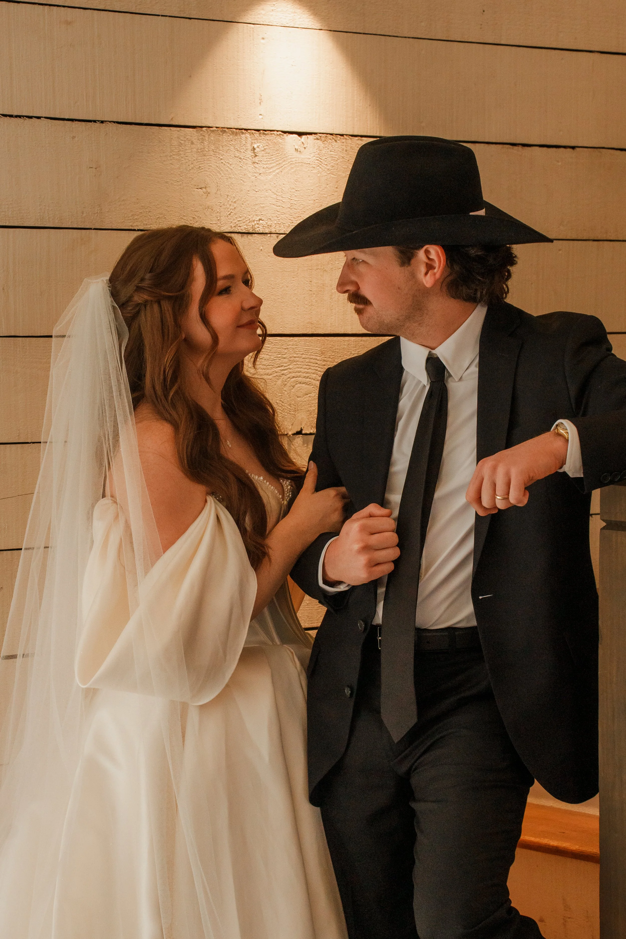 Bride and Groom looking into each other's eyes with linked arms