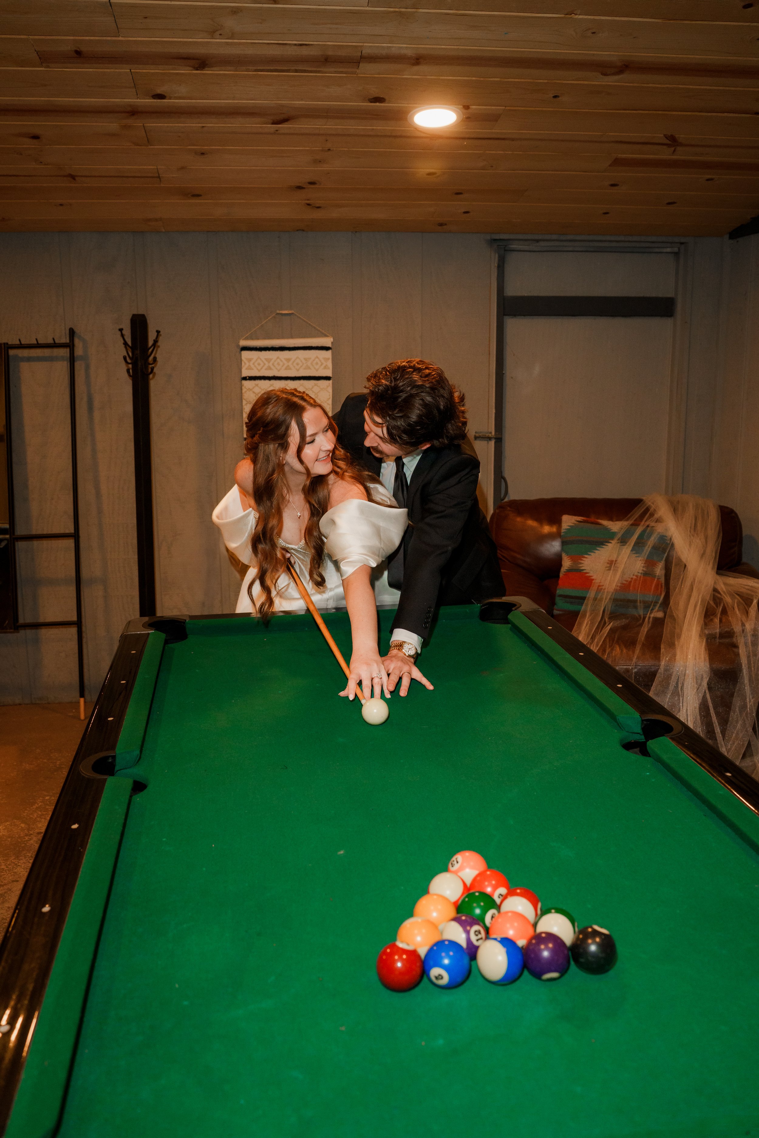 Bride and groom playing pool