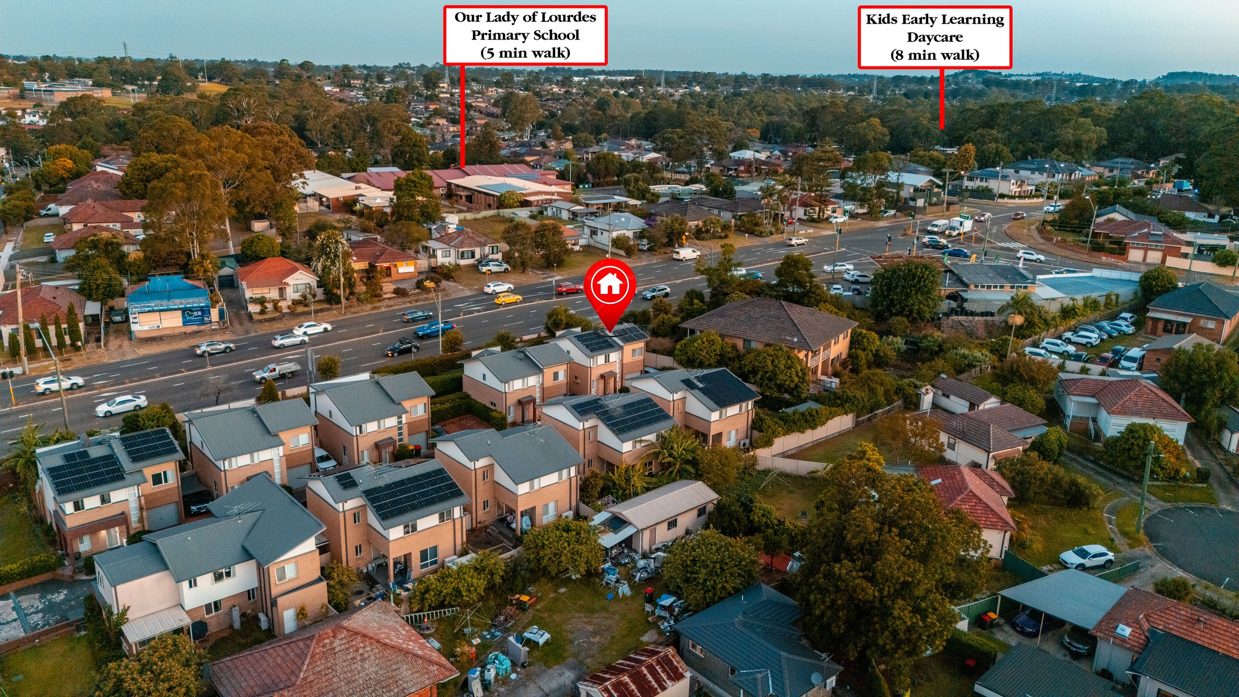 Aerial view of a residential neighborhood with houses, trees, and streets. Two locations are marked: 'Our Lady of Lourdes Primary School' (a 5-minute walk) and 'Kids Early Learning Daycare' (an 8-minute walk).