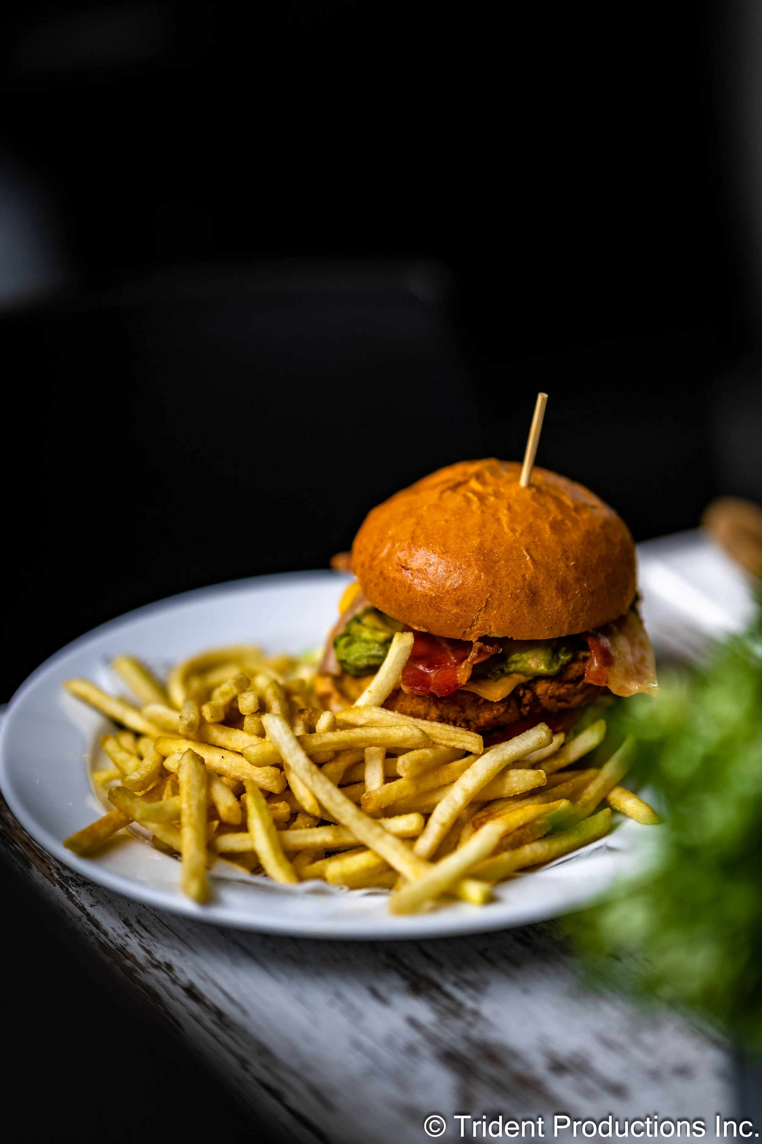 Cheeseburger with fries on a white plate