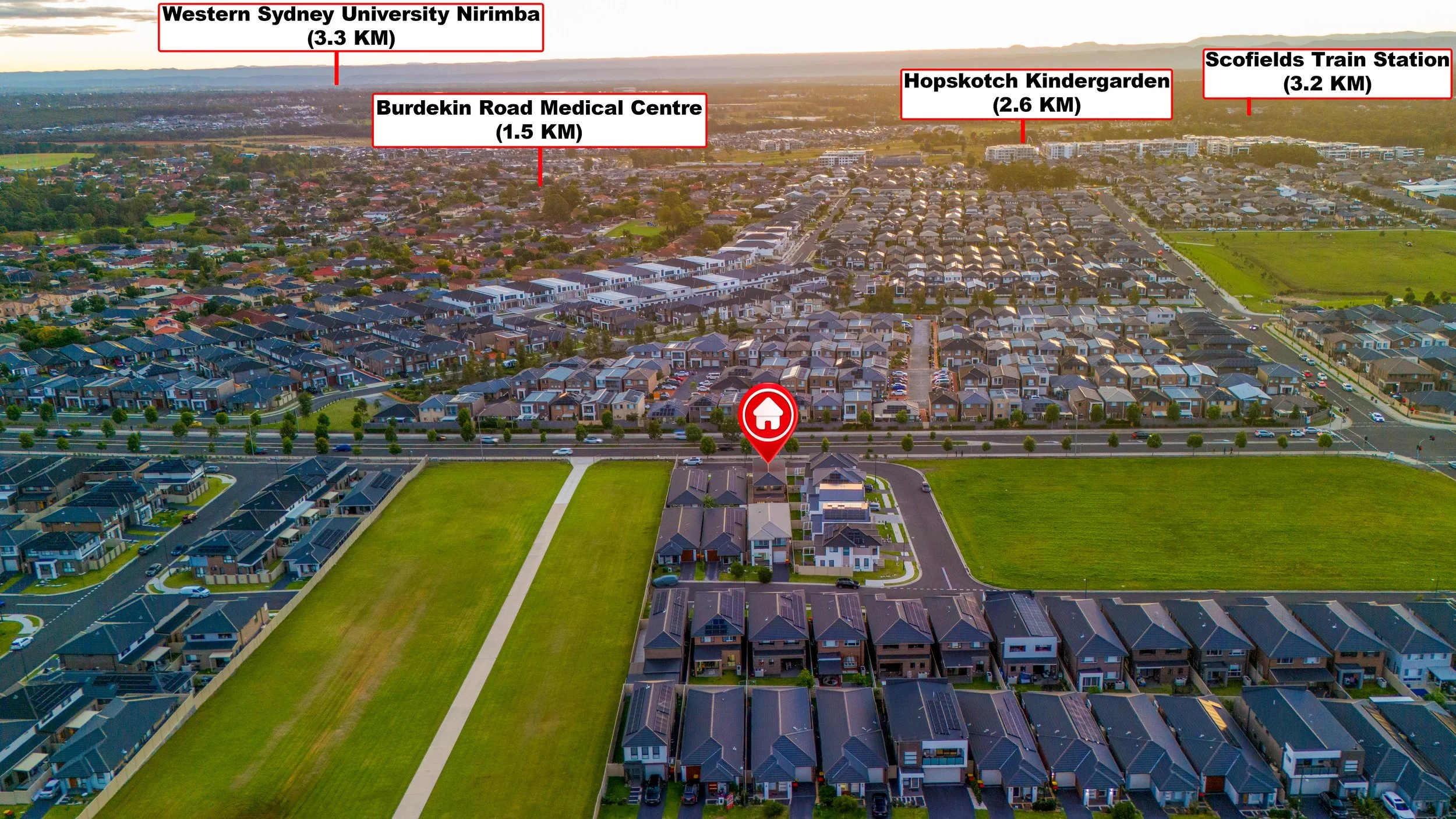 Aerial view of a suburban neighborhood with roads, houses, and green fields. Labels identify locations and distances, including Western Sydney University Nirimba, Burdekin Road Medical Centre, Hopskotch Kindergarten, and Scofields Train Station.
