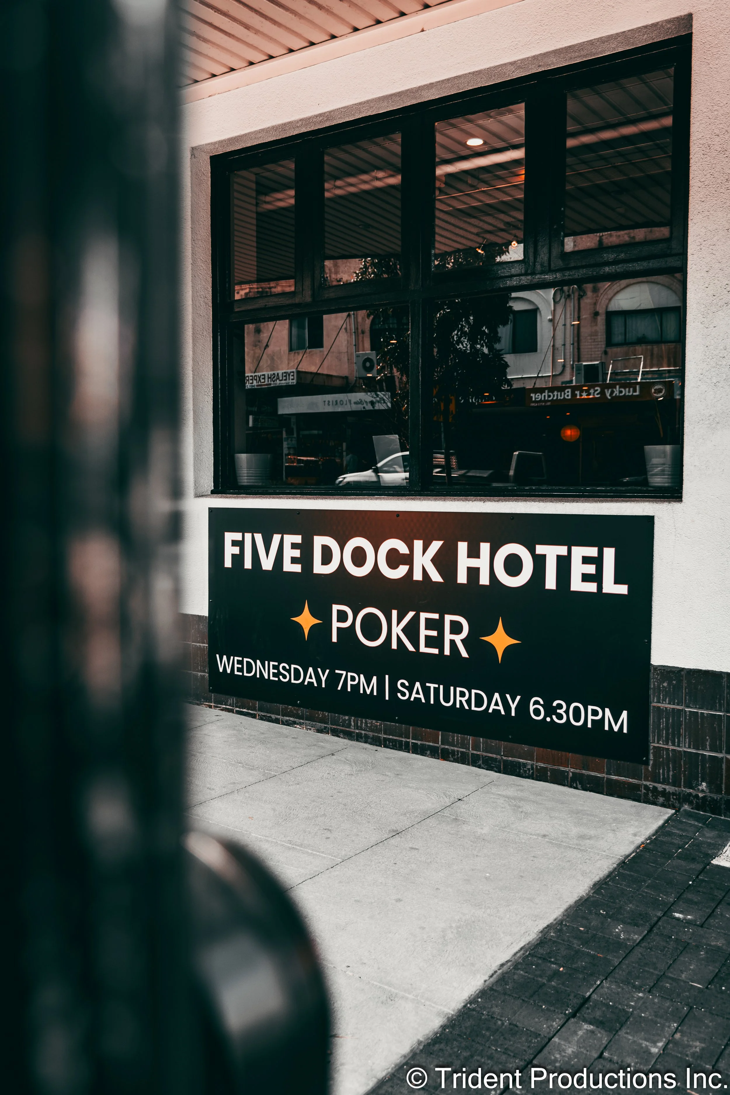 A sign outside the Five Dock Hotel advertising poker nights on Wednesday at 7 pm and Saturday at 6:30 pm.