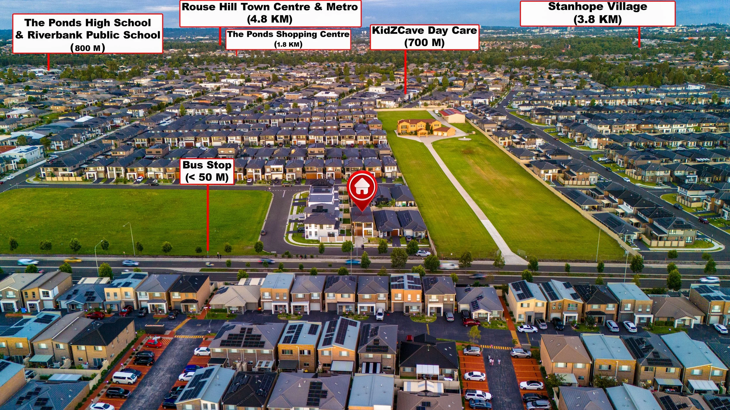 Aerial view of a suburban neighborhood with houses, green parks, and roads. Various landmarks are labeled, including schools, shopping centers, a bus stop, day care, and villages, with distances in meters or kilometers.