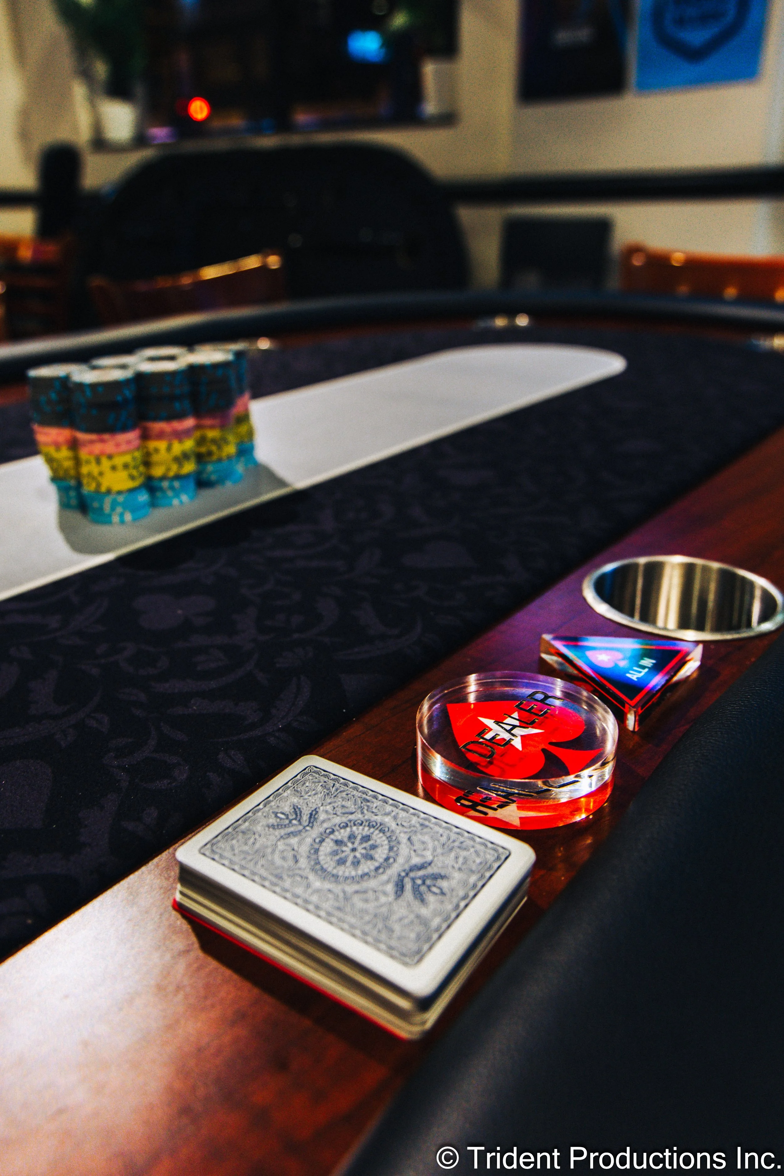 Poker chips, playing cards, and poker-themed accessories on a casino table.