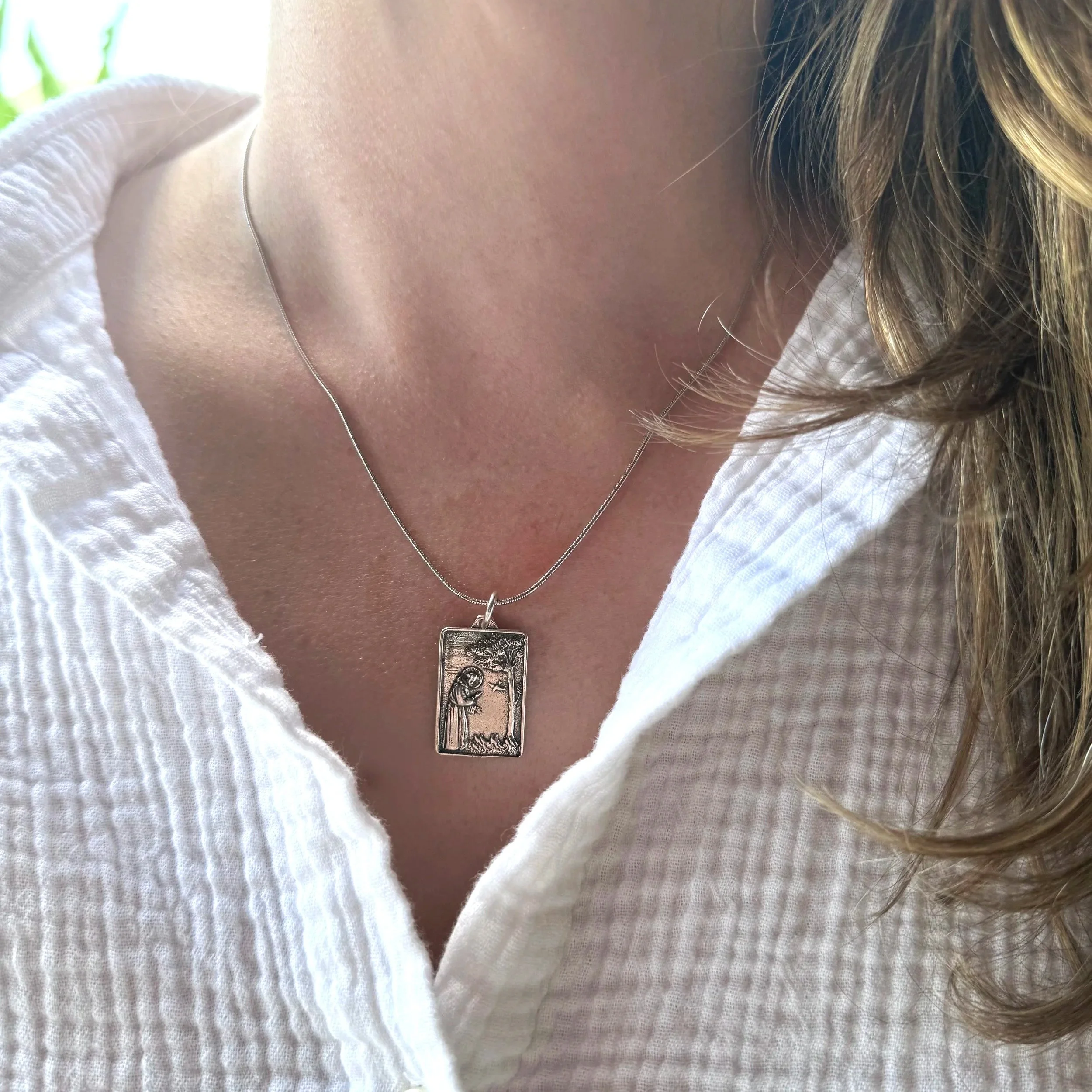 Woman wearing Zen Wave Creations' Guardian of Peace | Frequency Infused St. Francis Medal