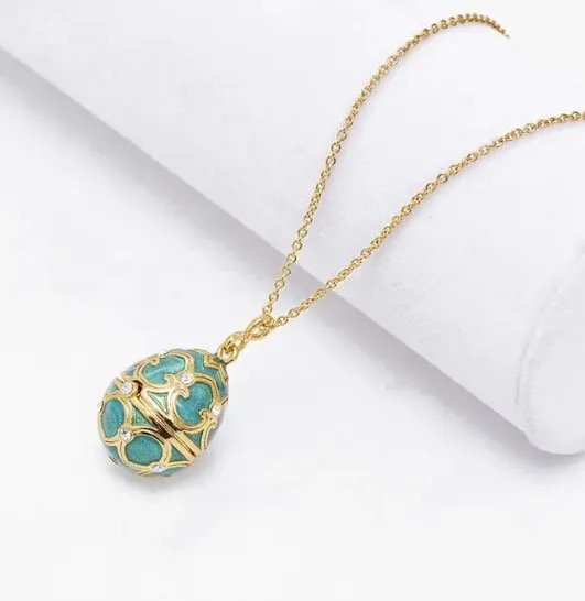 Frequency-infused green egg pendant on 24k gold chain.