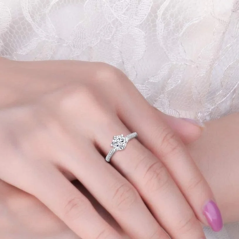 Woman's hand wearing a Stellar Embrace Moissanite Diamond Engagement Ring
