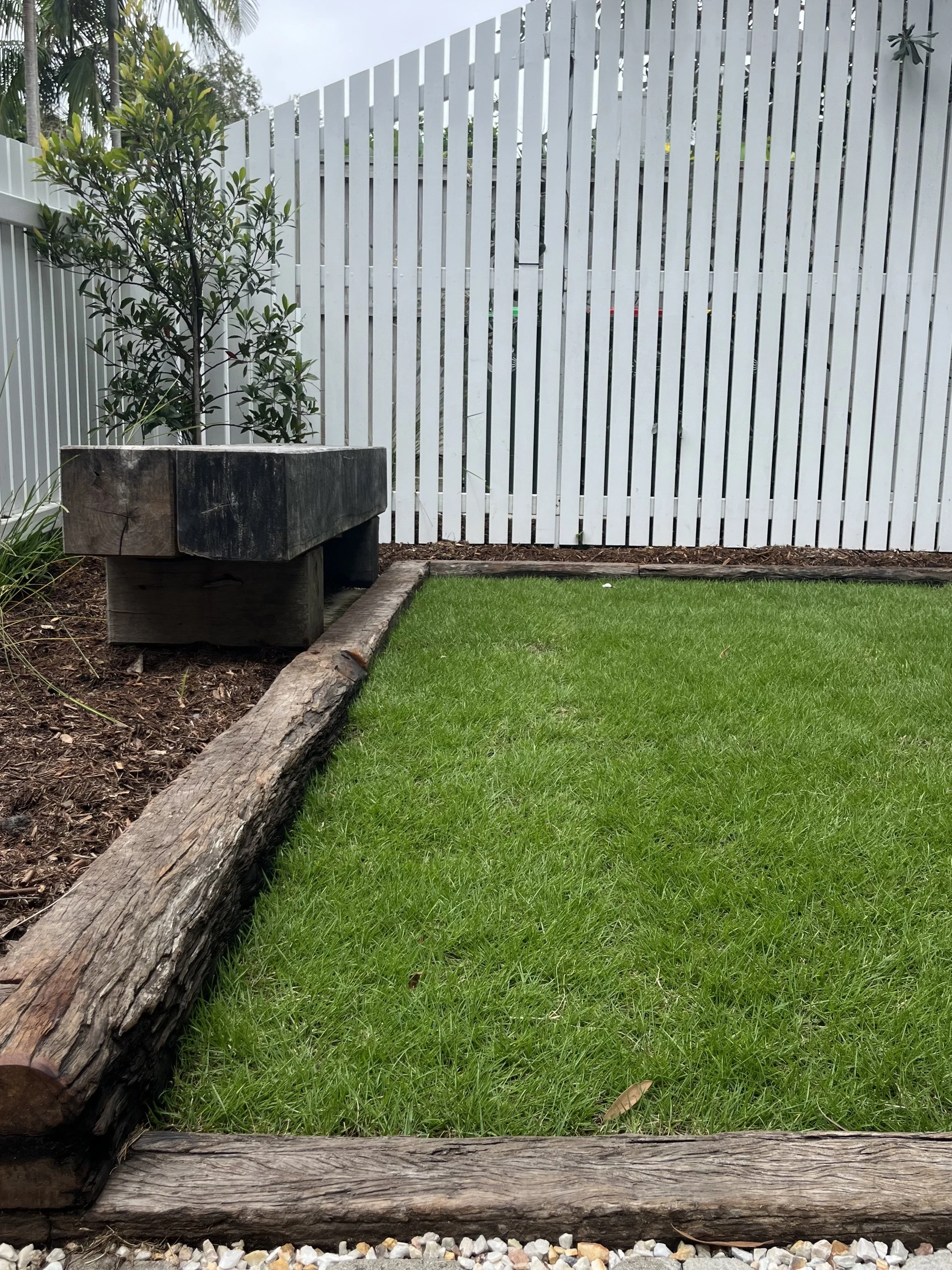 Byron Bay Landscape, Beautiful trees, Xanthorrhoea, Lennox, Turf, Sleepers, Edging, Timber screen, White fence, Privacy screening, recycled timber, Outdoor shower, Paving, landscape furniture, Arbour,  Wellness space, landscape Design.