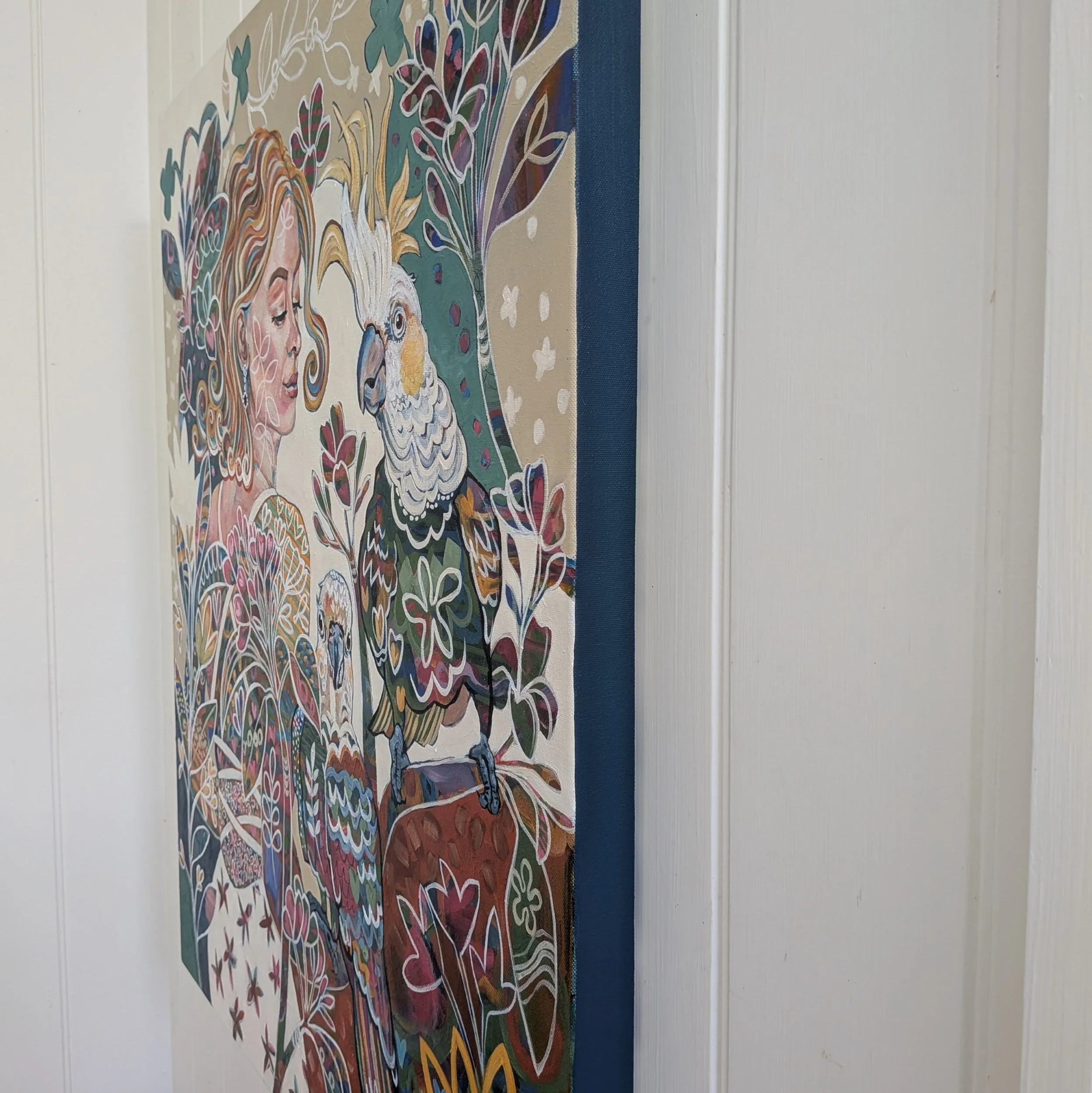 woman-holding-cockatoos-garden view-pink frangipanies.jpg