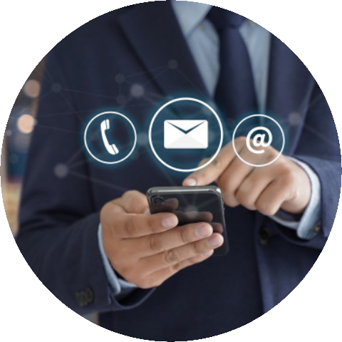 A person in a suit using a smartphone with icons for phone, email, and at-sign floating above the device.