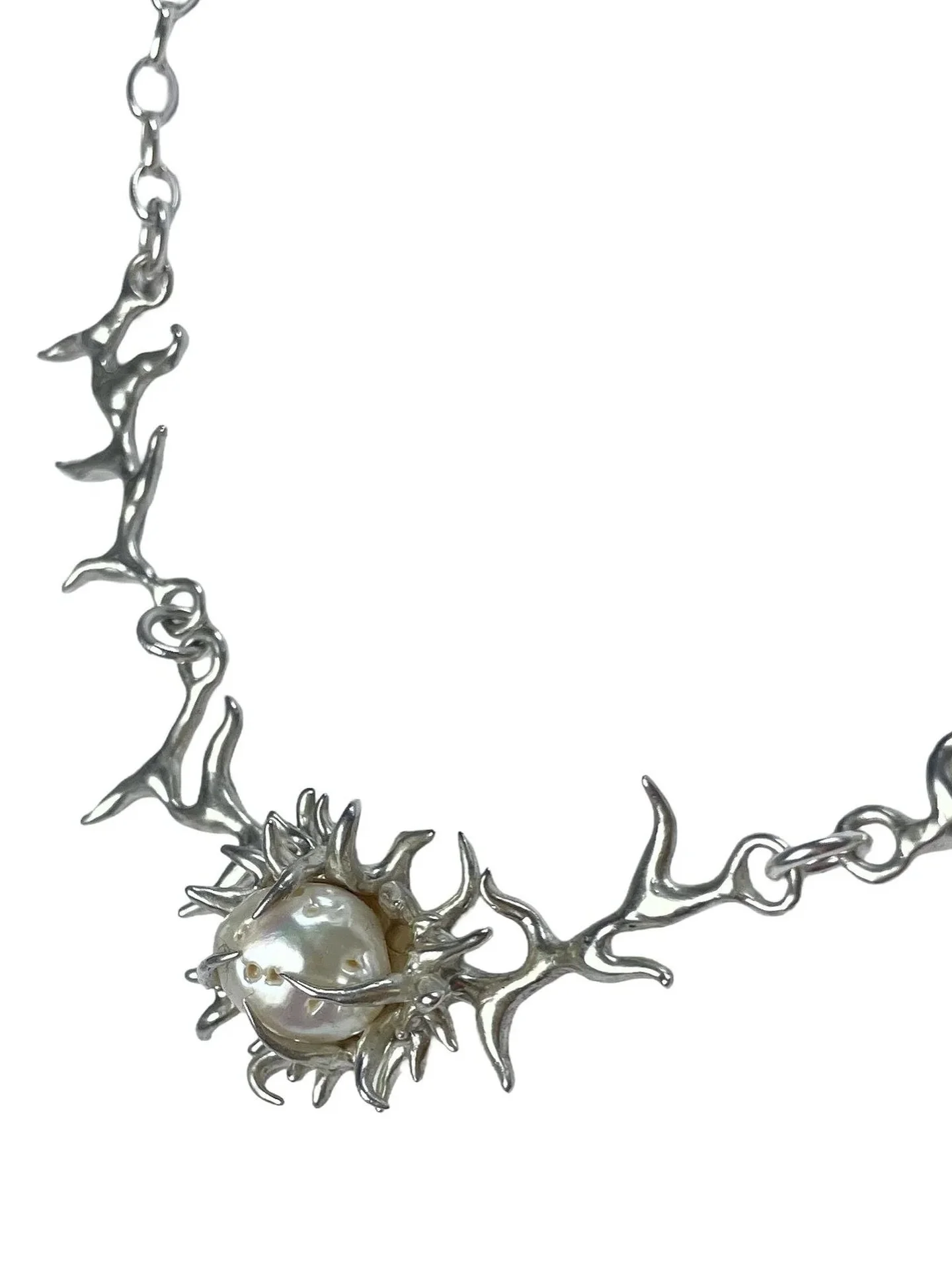 The thorn necklace by @stettin.jewellery is everything. 
Handcarved in solid 925 silver, thorns wrapped around a supersized natural baroque pearl in a sculptural design, Each necklace piece is a one of a kind, shaped by the unique form of the pearl