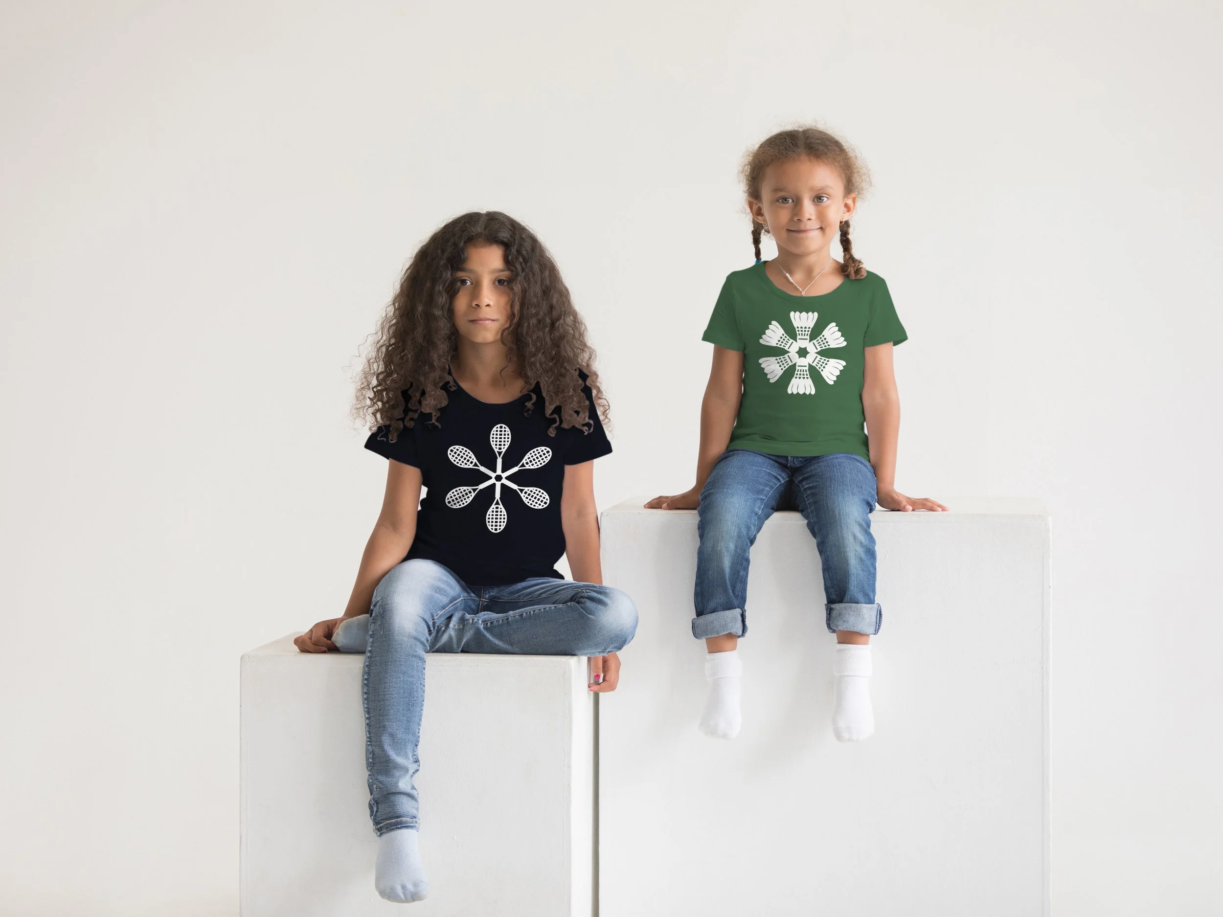 Two kids wearing tshirts with racket sports snowflake designs