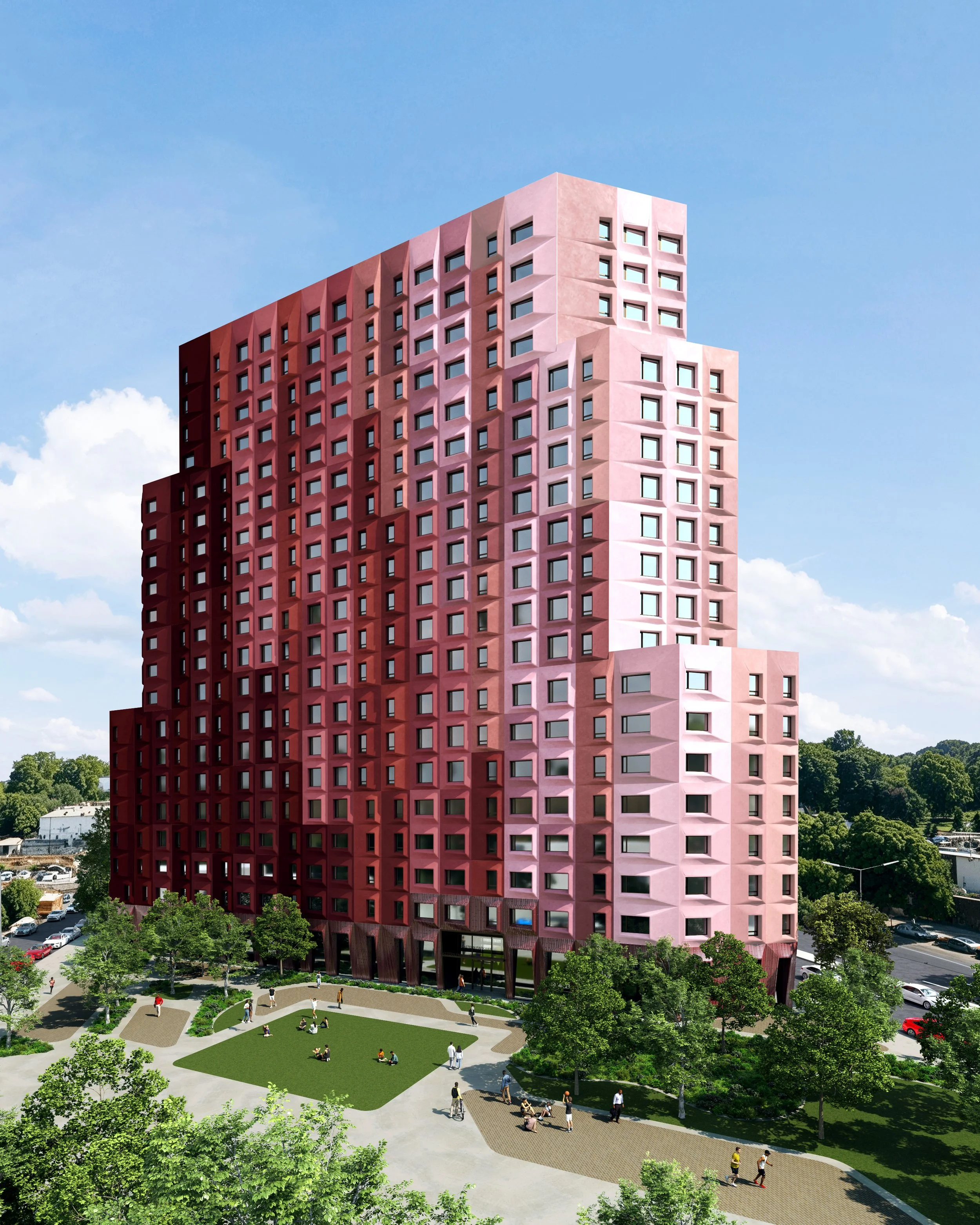 A modern pink high-rise building with grid-like windows, set against a blue sky. The building is viewed from a park with green trees, a walking path, and people relaxing on the grass and walking.