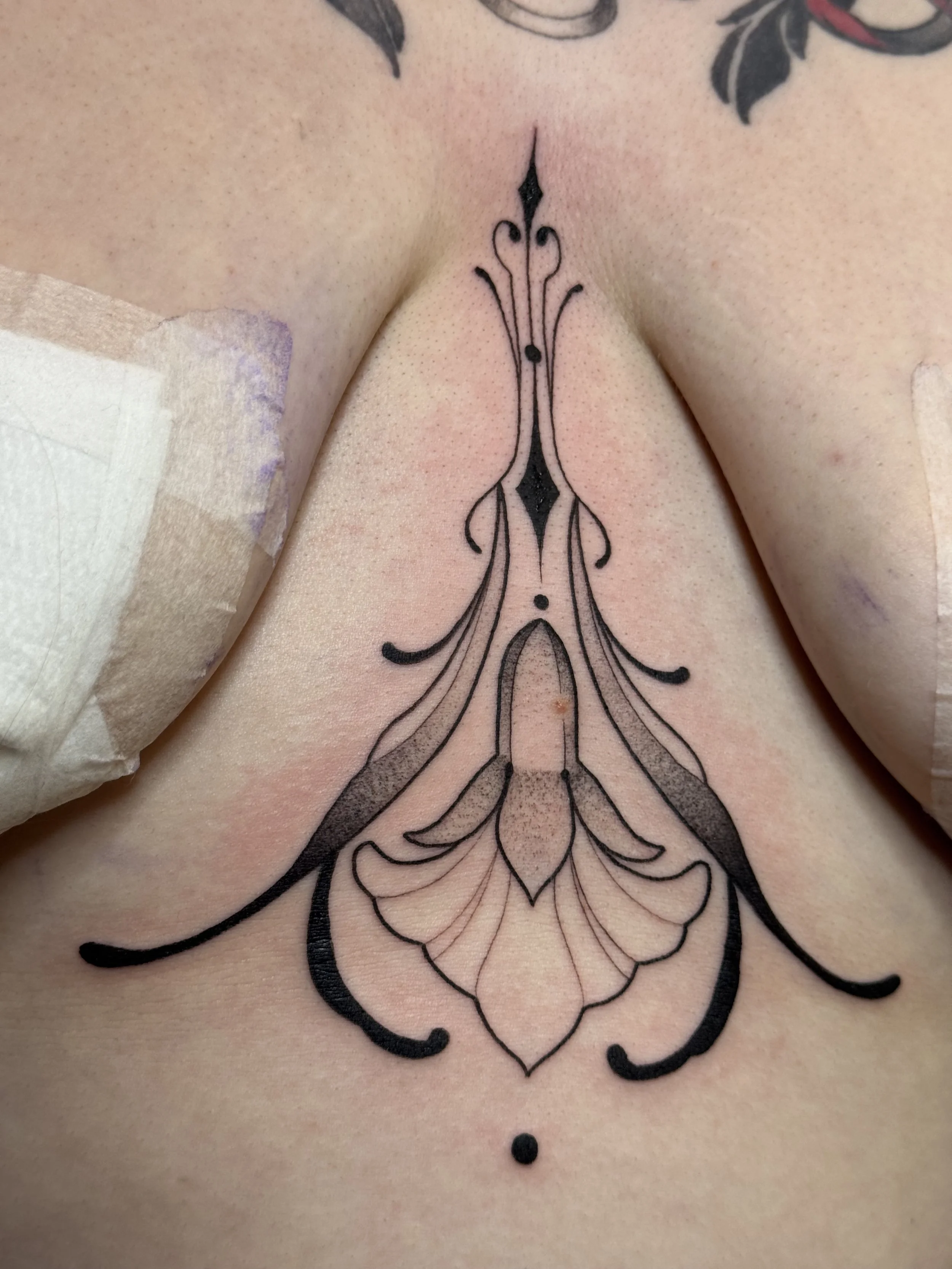 Underboob/sternum/stomach ornamental blackwork flower
