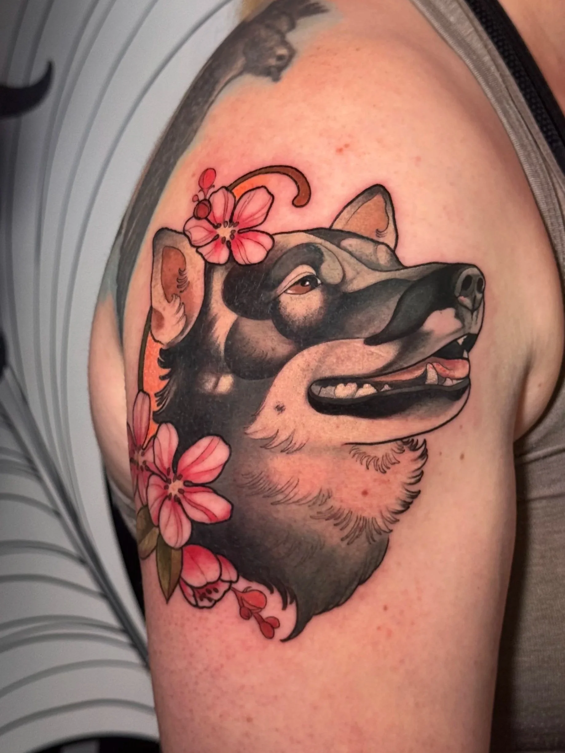 Neotraditional dog portrait tattoo with apple flowers 