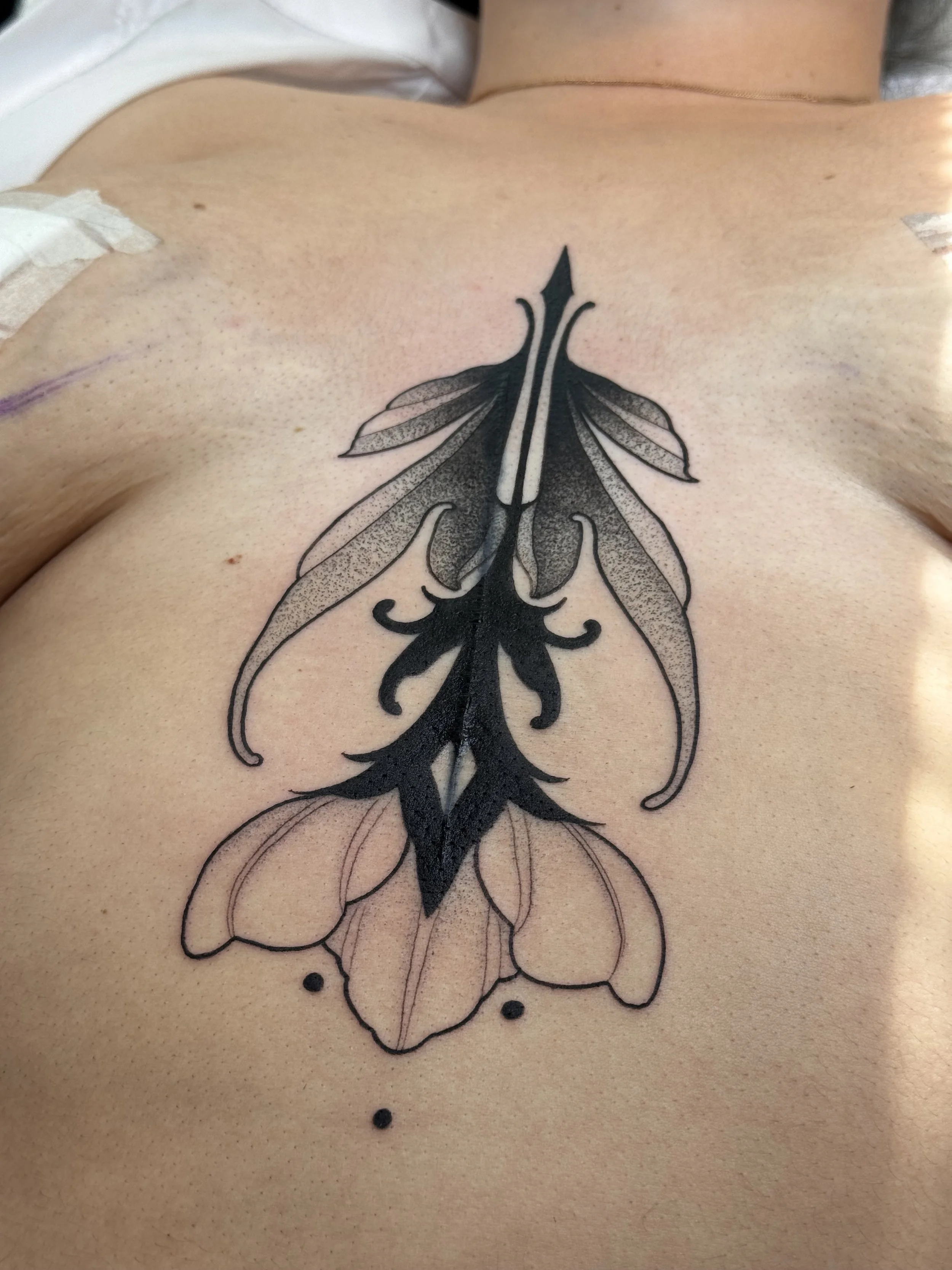 Ornamental flower blackwork coverup underboob sternum tattoo