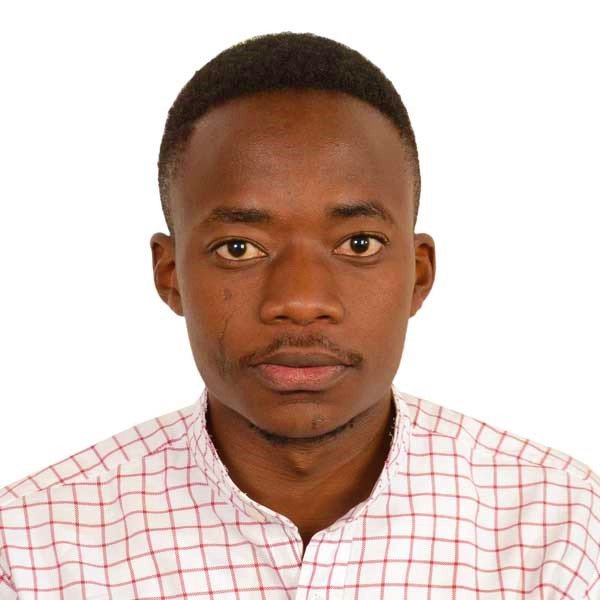 Portrait of a young man with short hair wearing a pink and white checkered shirt against a white background.