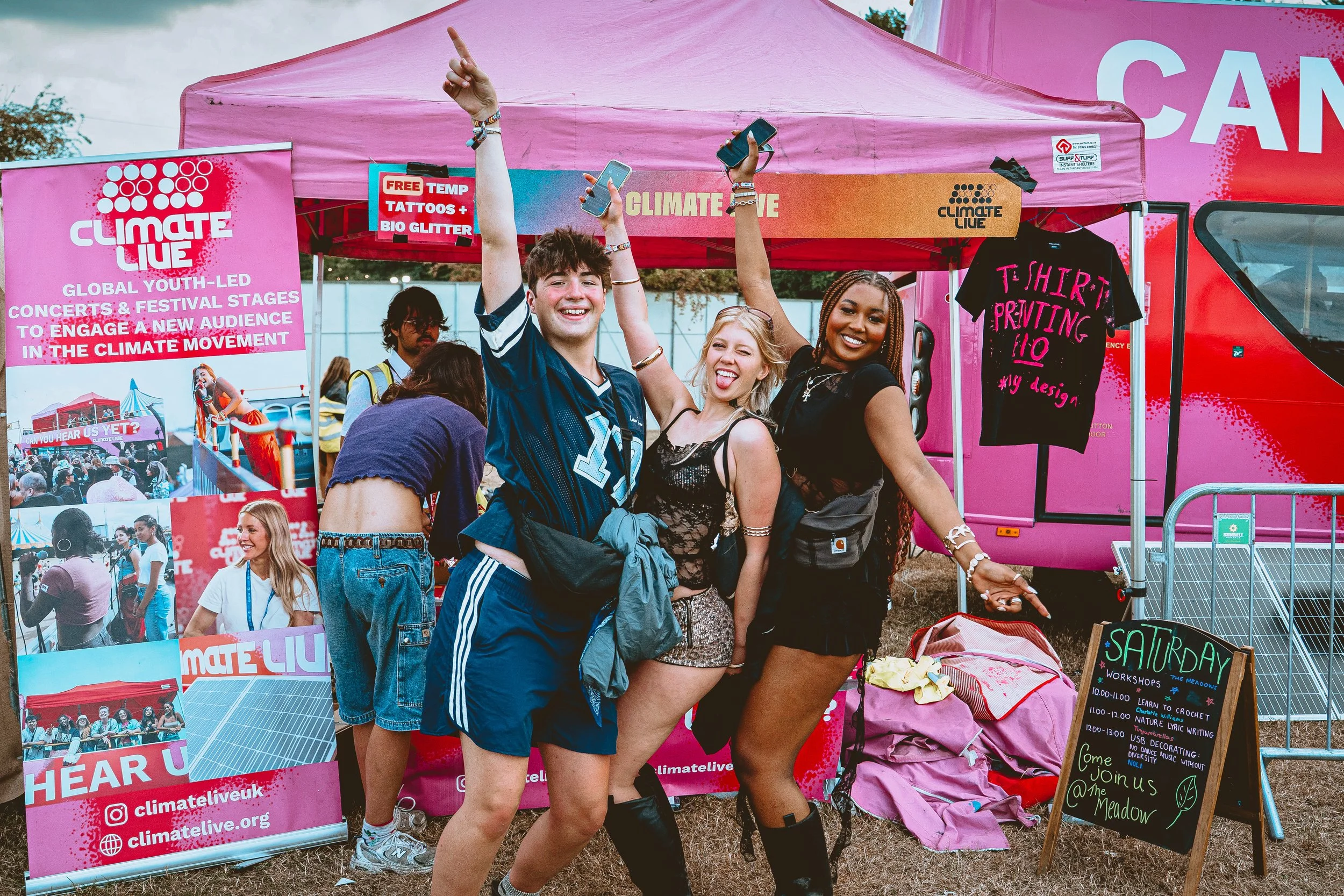 Laptop displaying a video conference with multiple participants, placed on a wooden table next to a ceramic coffee mug, in a cozy indoor setting.