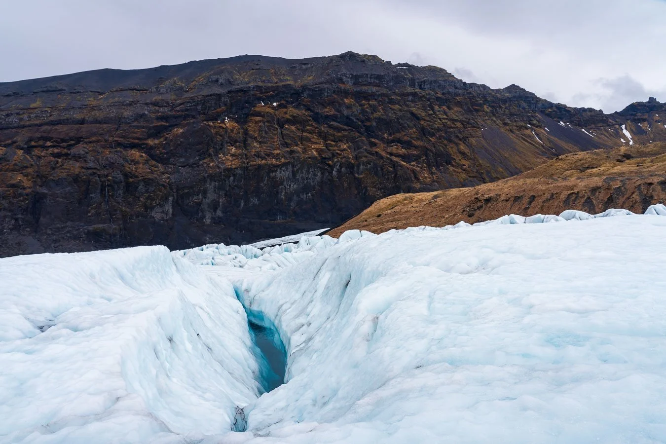   Falljökull , an outlet glacier of Vatnajökull, is renowned for its striking blue ice formations and crevasses, making it a popular destination for glacier hikes. 