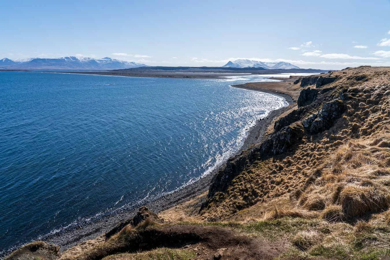  The coastline around  Hvítserkur  is characterized by sweeping views of  Húnafjörður Bay , dramatic cliffs, and tufts of golden grasslands. 