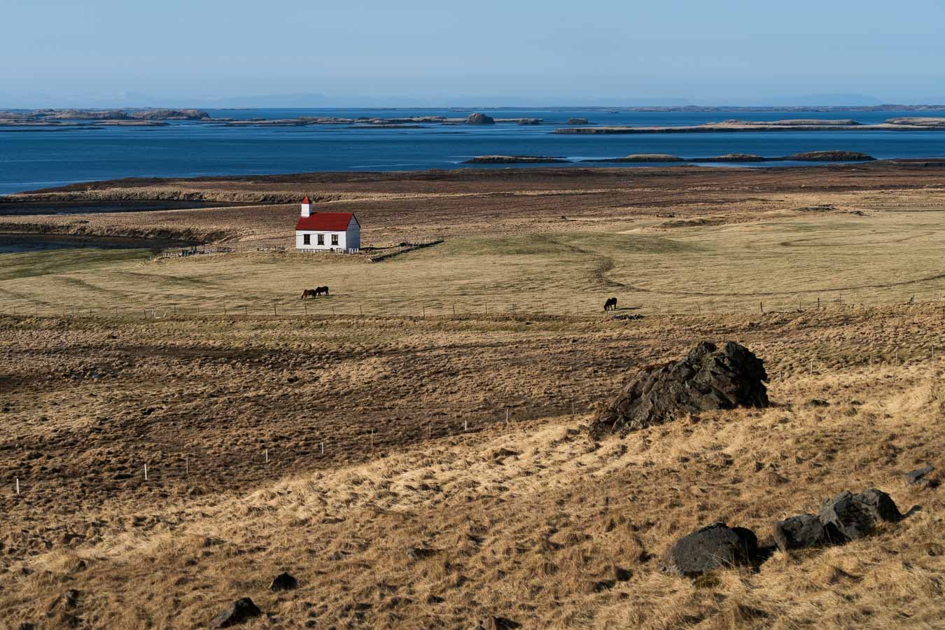  Circling the island, you’ll encounter countless picturesque scenes like this charming countryside church, nestled against a backdrop of peaceful fields and coastal views. 
