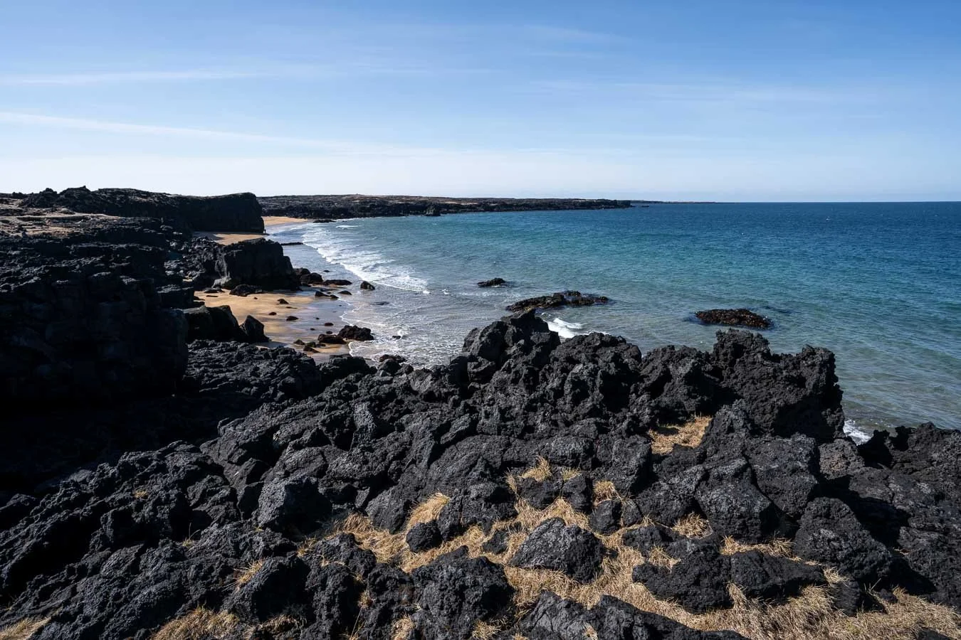  Nestled amidst black lava fields,  Skarðsvík Beach  surprises visitors with its golden sands, a rarity in Iceland, offering a stark contrast to the volcanic landscape. 