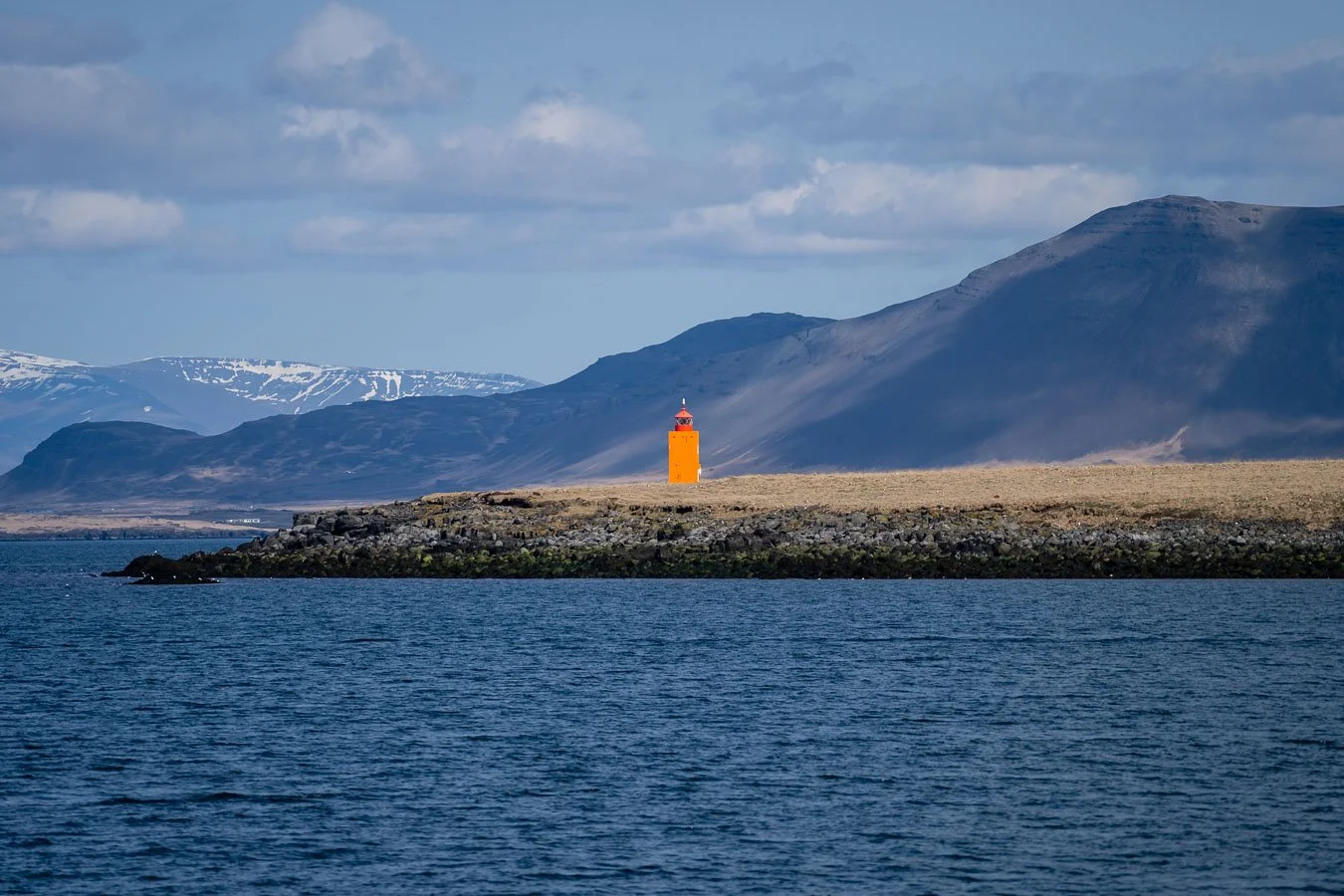orange-lighthouse-coast-reykjavik-iceland.jpg