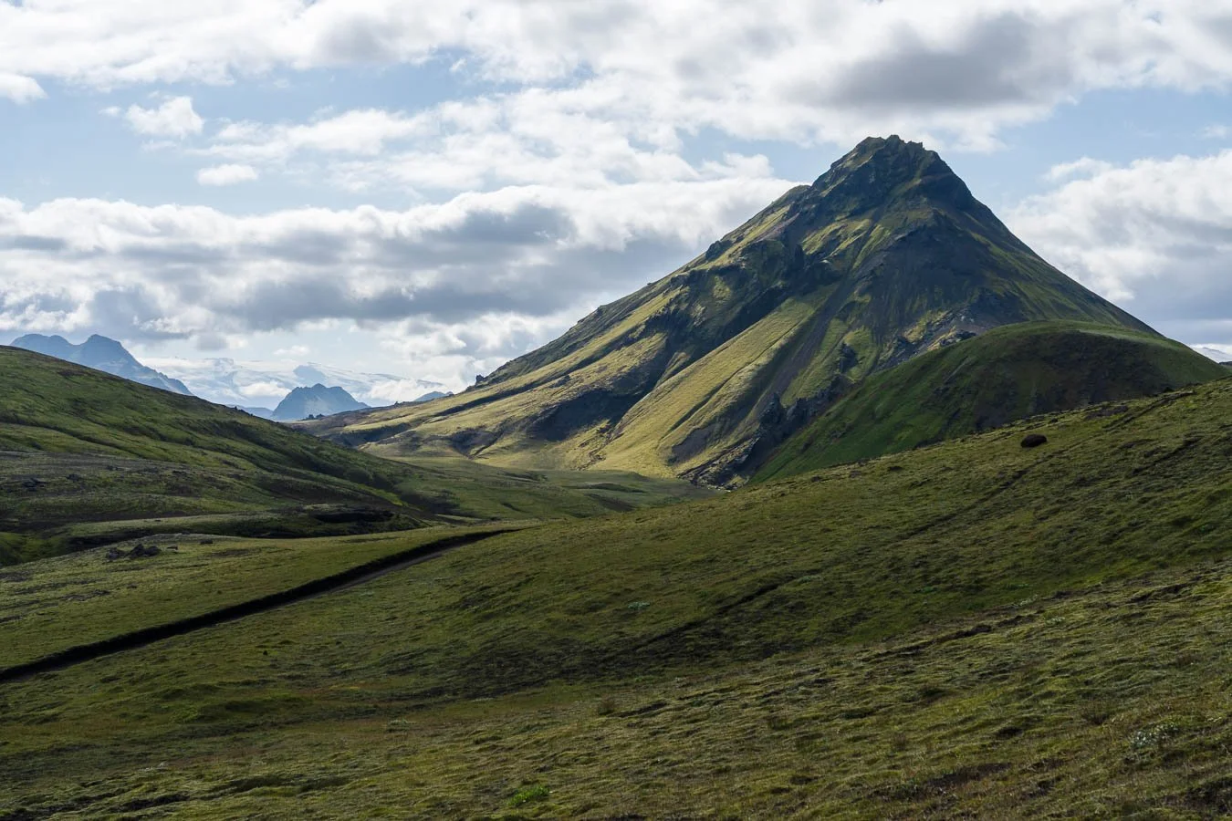  Between  Hvanngil  and  Álftavatn , the terrain becomes temporarily slightly more lush, with intensely green grass and moss-covered hills. 