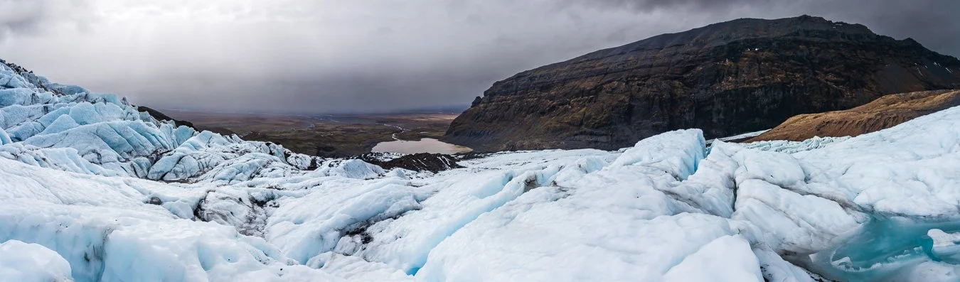 Panoramic view from the final point of the glacier hike on Svinafellsjökull Glacier overlooking a distant lagoon.