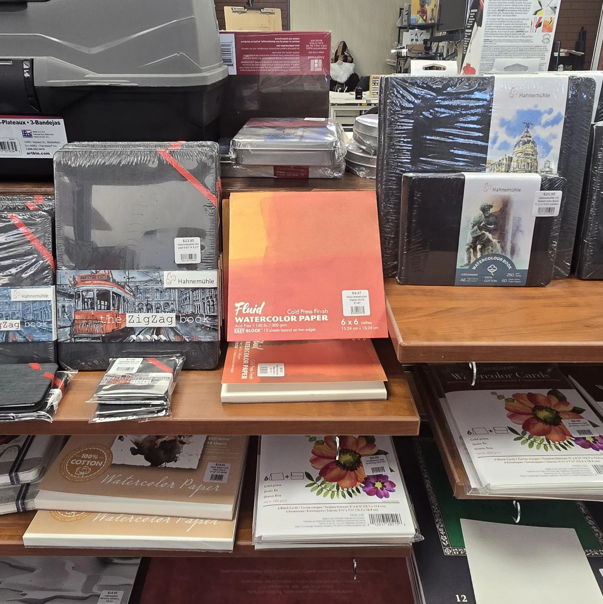A variety of watercolor and mixed media sketchbooks, white and toned