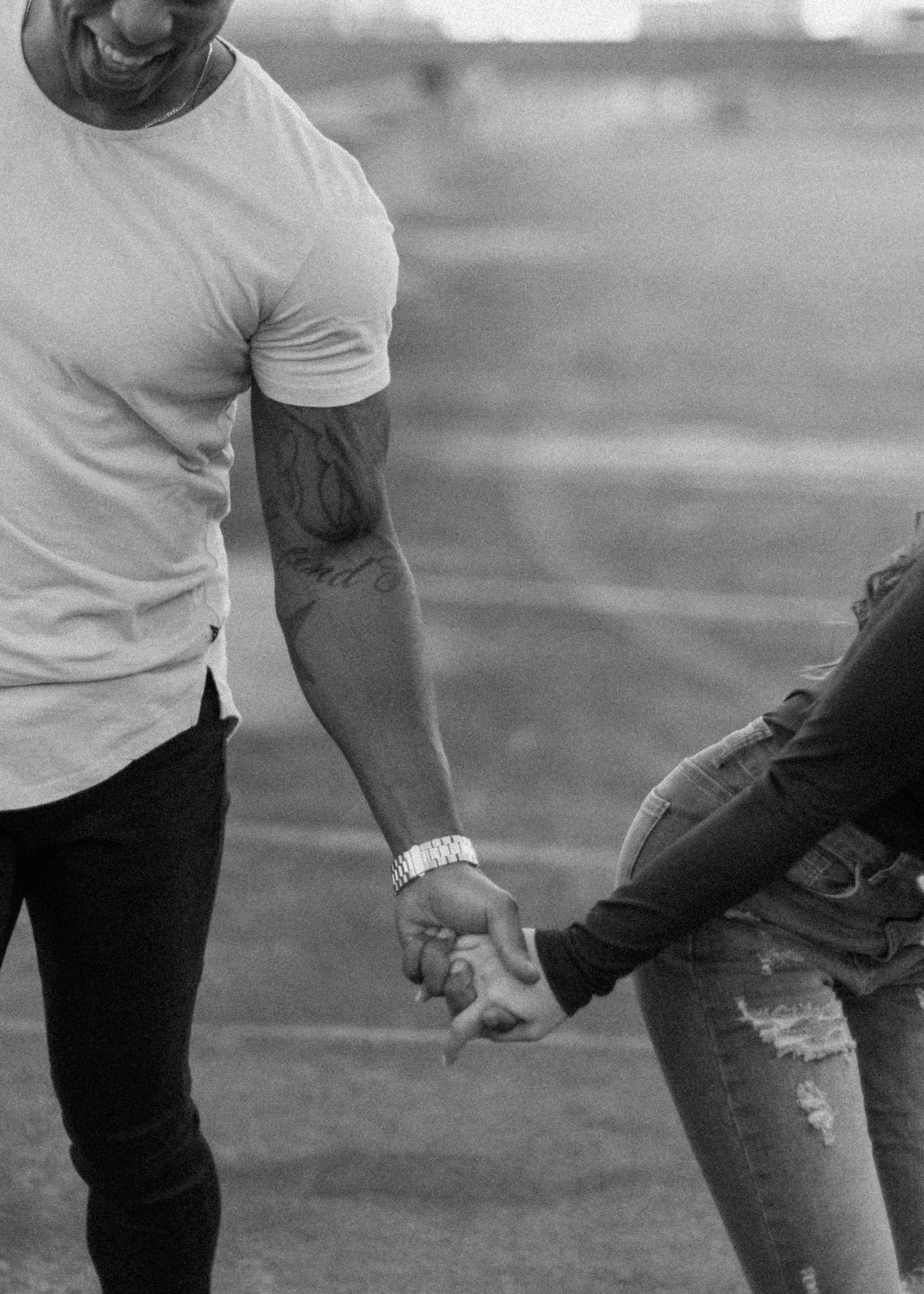 happy couple laughing, holding hands, seeking therapy