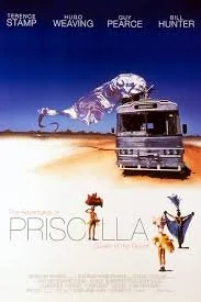 A poster for the movie 'Priscilla, Queen of the Desert,' featuring a desert scene with a bus and three characters in colorful costumes, one of whom is holding a small dog.